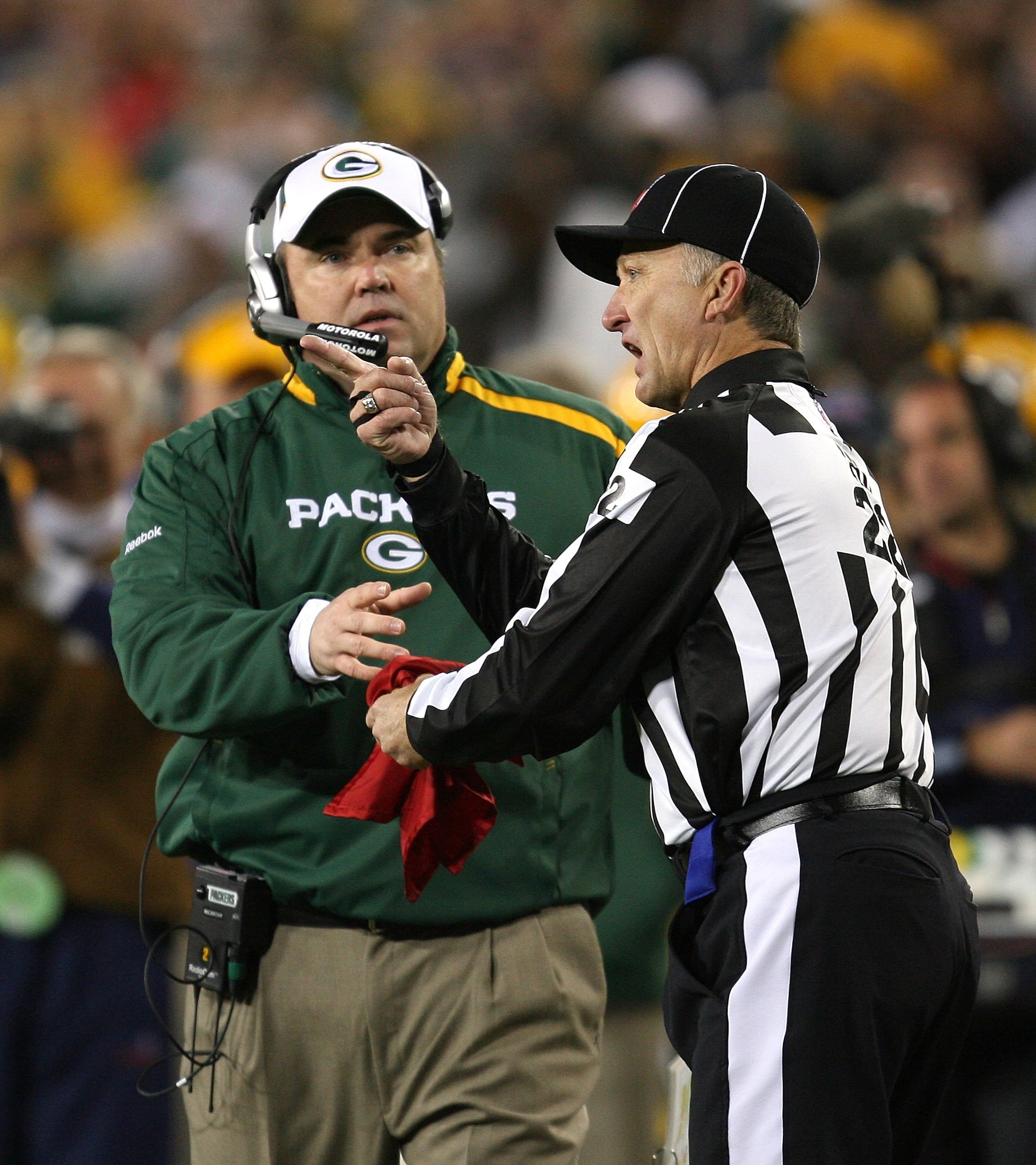GREEN BAY, WI - NOVEMBER 15: Head coach Mike McCarthy of the Green Bay Packers issues a challenge by giving the red flag to head lineman Steve Stelljes #22 during a game against the Dallas Cowboys at Lambeau Field on November 15, 2009 in Green Bay, Wiscon