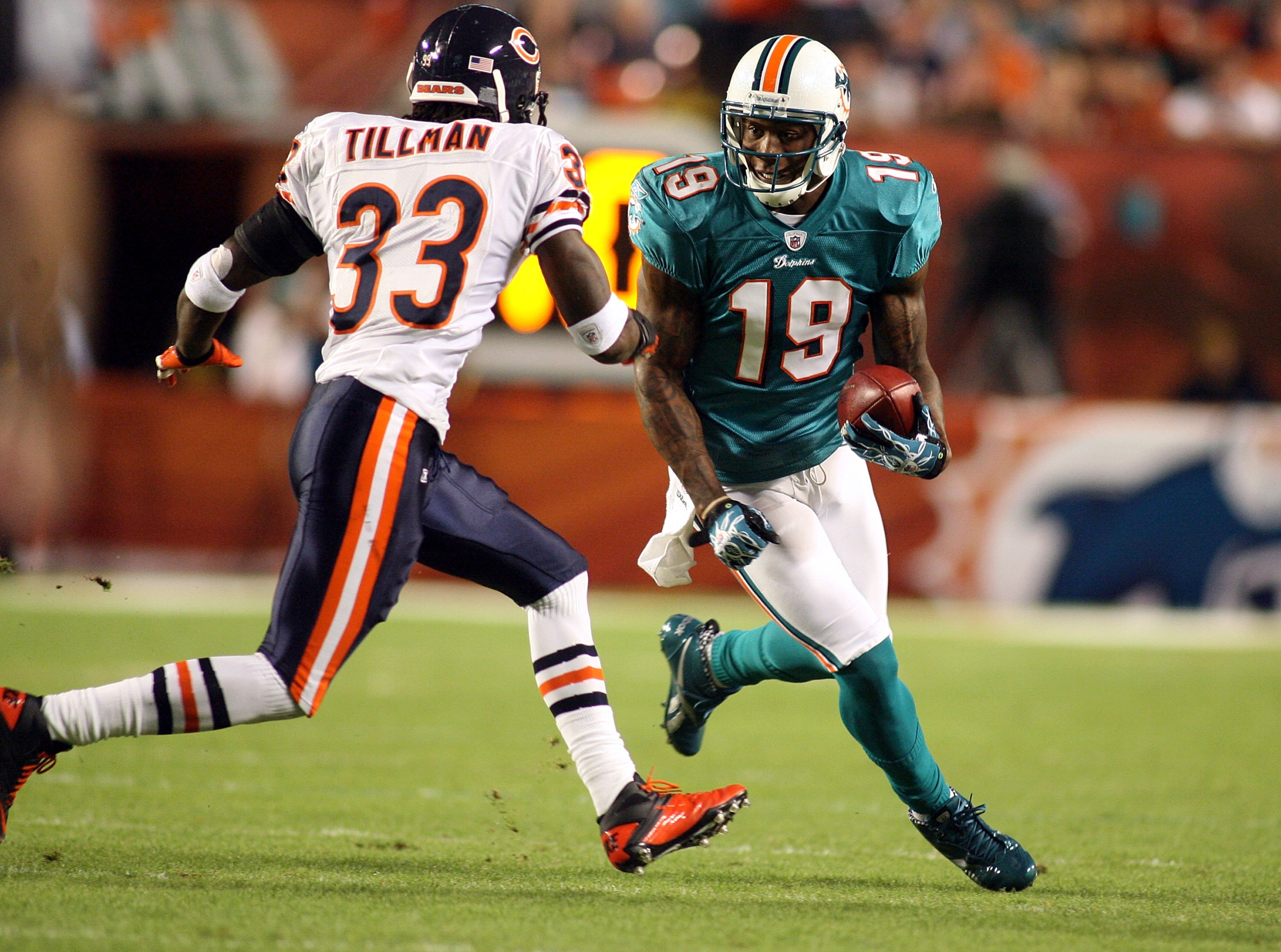 MIAMI - NOVEMBER 18:  Receiver Brandon Marshall #19 of the Miami Dolphins runs as safety Charles Tillman #33 of the Chicago Bears defends at Sun Life Stadium on November 18, 2010 in Miami, Florida.  (Photo by Marc Serota/Getty Images)
