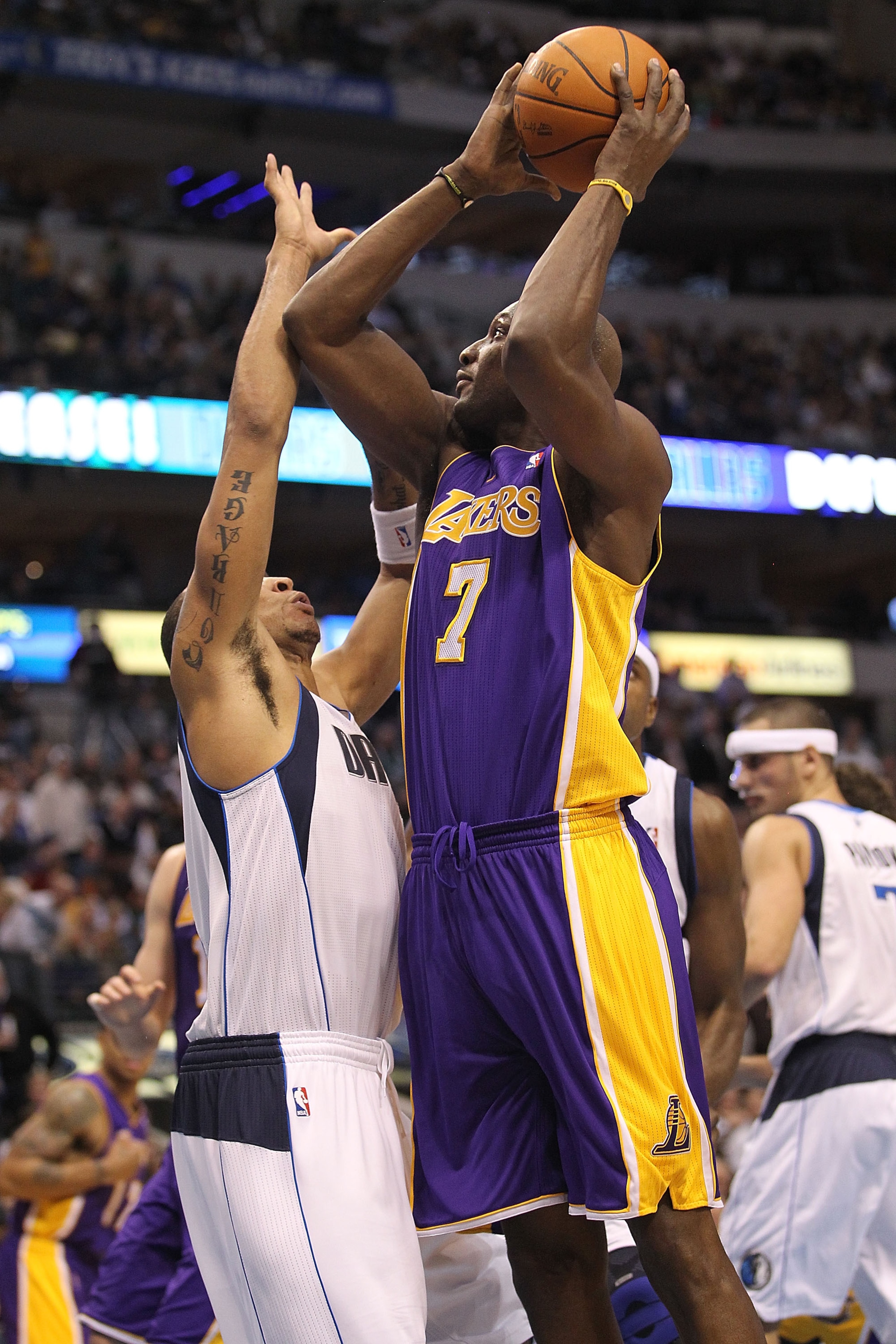 DALLAS, TX - JANUARY 19:  Forward Lamar Odom #7 of the Los Angeles Lakers takes a shot against Shawn Marion #0 of the Dallas Mavericks at American Airlines Center on January 19, 2011 in Dallas, Texas.  NOTE TO USER: User expressly acknowledges and agrees