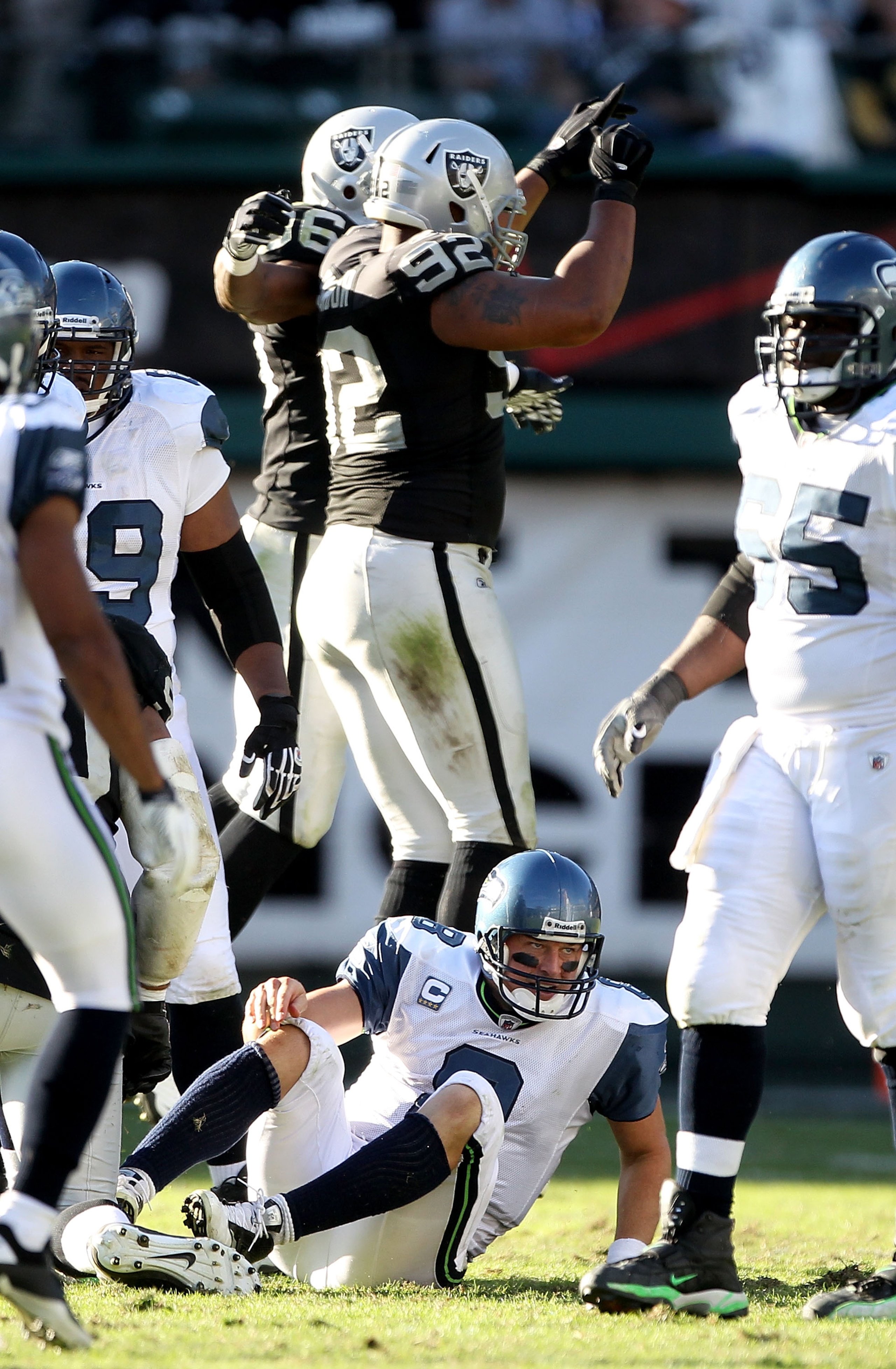 OAKLAND, CA - OCTOBER 31:  Matt Hasselbeck #8 of the Seattle Seahawks gets off the ground after he was sacked by Richard Seymour #92 of the Oakland Raiders at Oakland-Alameda County Coliseum on October 31, 2010 in Oakland, California.  (Photo by Ezra Shaw