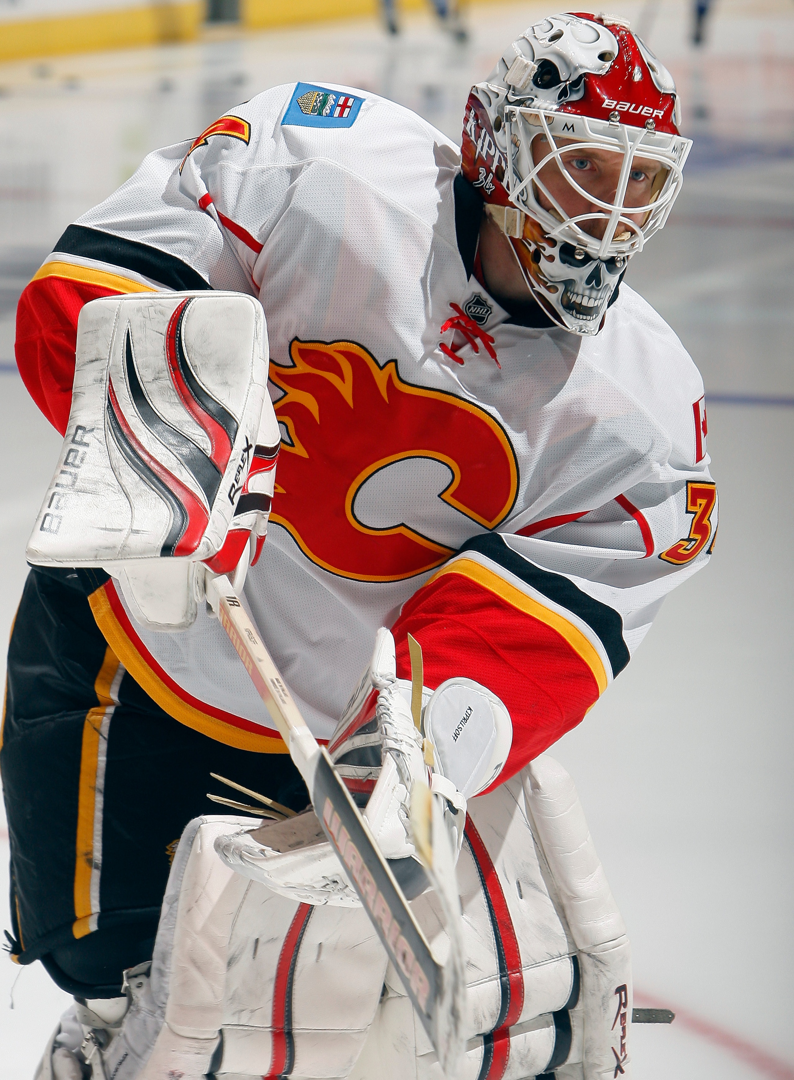 TORONTO, CANADA - JANUARY 15:  Miikka Kiprusoff #34 of the Calgary Flames shoots during warmup before game action against the Toronto Maple Leafs at the Air Canada Centre January 15, 2011 in Toronto, Ontario, Canada. (Photo by Abelimages/Getty Images)
