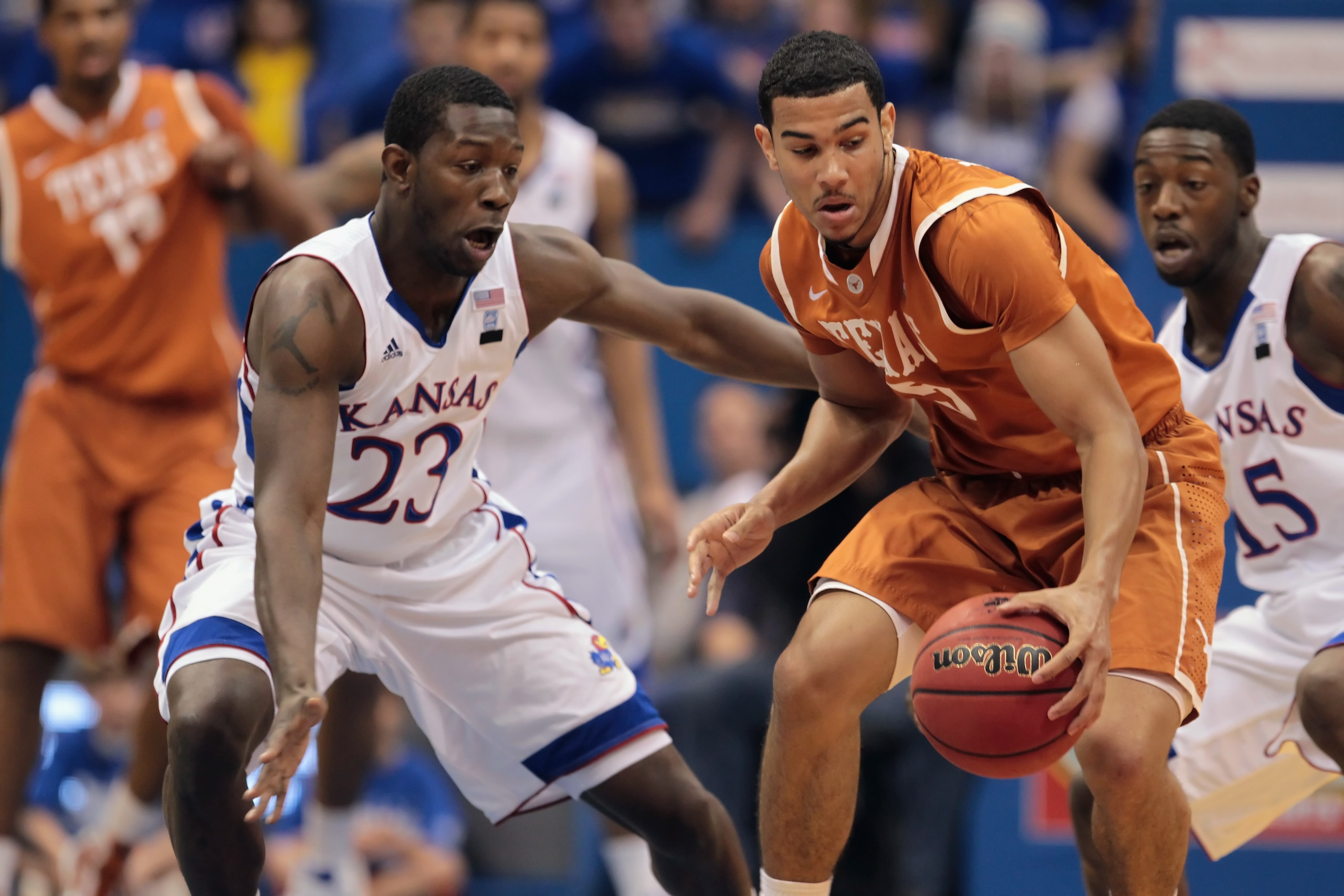 LAWRENCE, KS - JANUARY 22:  Cory Joseph #5 of the Texas Longhorns controls the ball as Mario Little #23 of the Kansas Jayhawks defends during the game on January 22, 2011 at Allen Fieldhouse in Lawrence, Kansas.  (Photo by Jamie Squire/Getty Images)