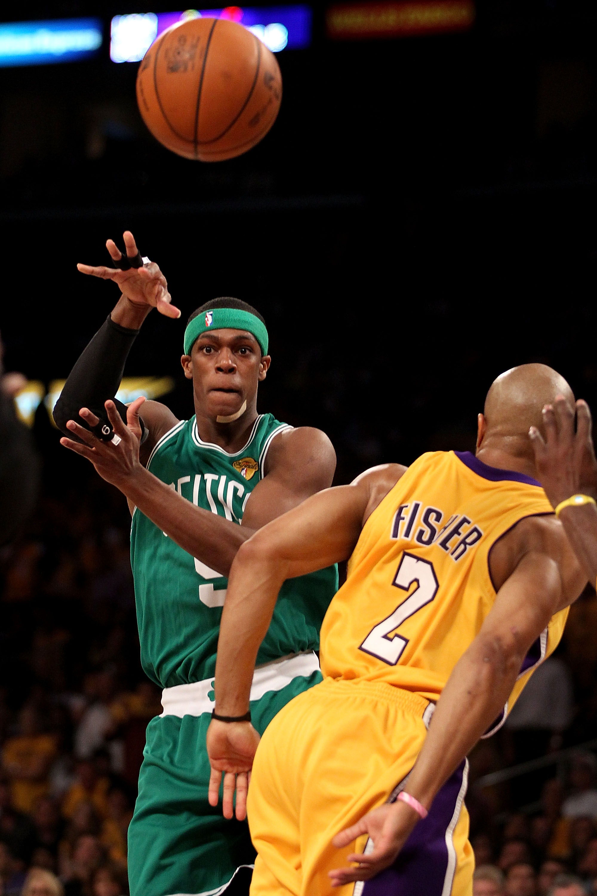LOS ANGELES, CA - JUNE 17:  Rajon Rondo #9 of the Boston Celtics passes the ball over Derek Fisher #2 of the Los Angeles Lakers in Game Seven of the 2010 NBA Finals at Staples Center on June 17, 2010 in Los Angeles, California.  NOTE TO USER: User express