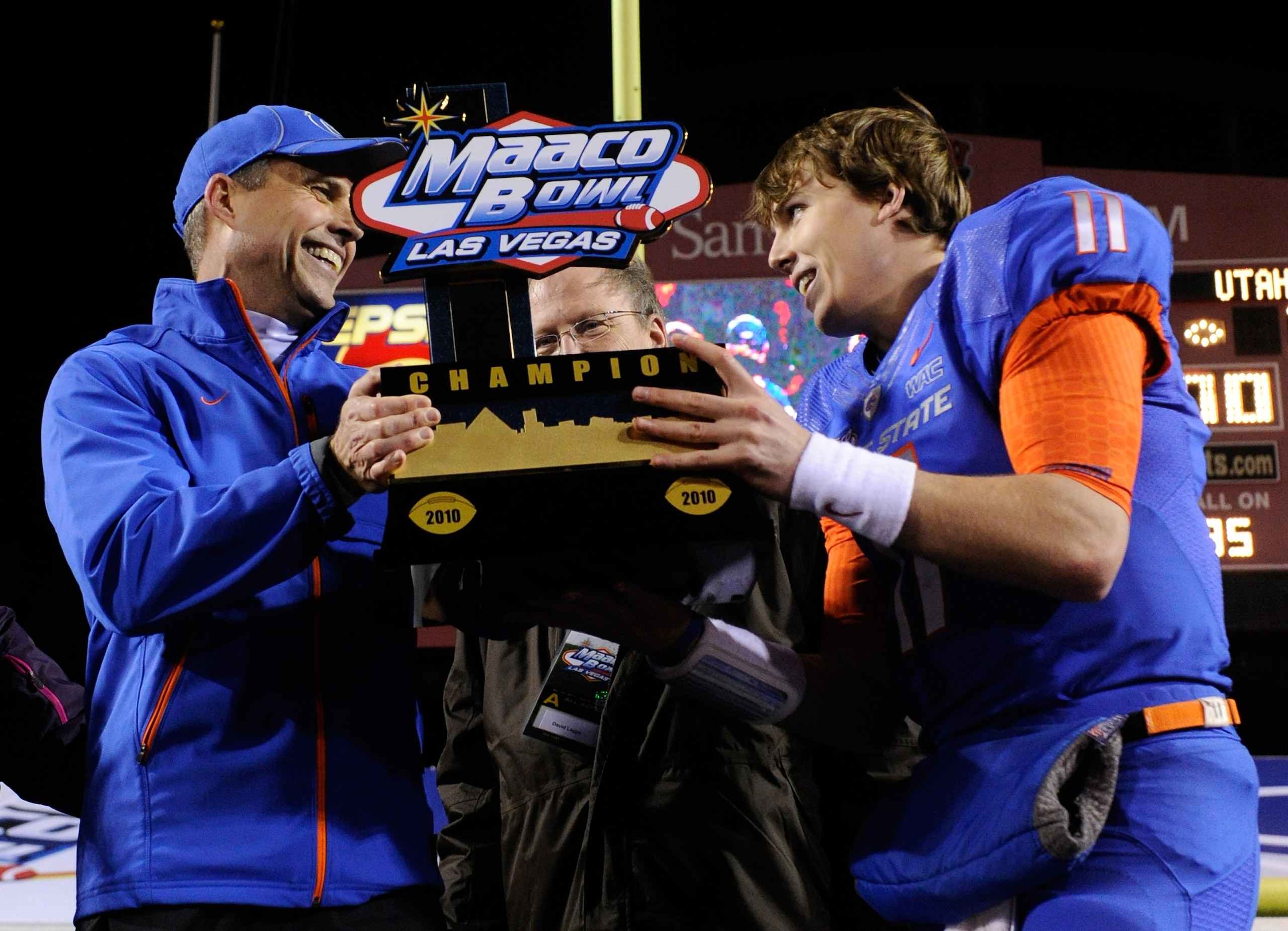 LAS VEGAS, NV - DECEMBER 22: Head coach Chris Petersen (L) and quarterback Kellen Moore #11 of the Boise State Broncos hold up a trophy as they celebrate their 26-3 victory over the Utah Utes in the MAACO Bowl Las Vegas at Sam Boyd Stadium December 22, 2 LAS VEGAS, NV - DECEMBER 22: Head coach Chris Petersen (L) and quarterback Kellen Moore #11 of the Boise State Broncos hold up a trophy as they celebrate their 26-3 victory over the Utah Utes in the MAACO Bowl Las Vegas at Sam Boyd Stadium December 22, 2