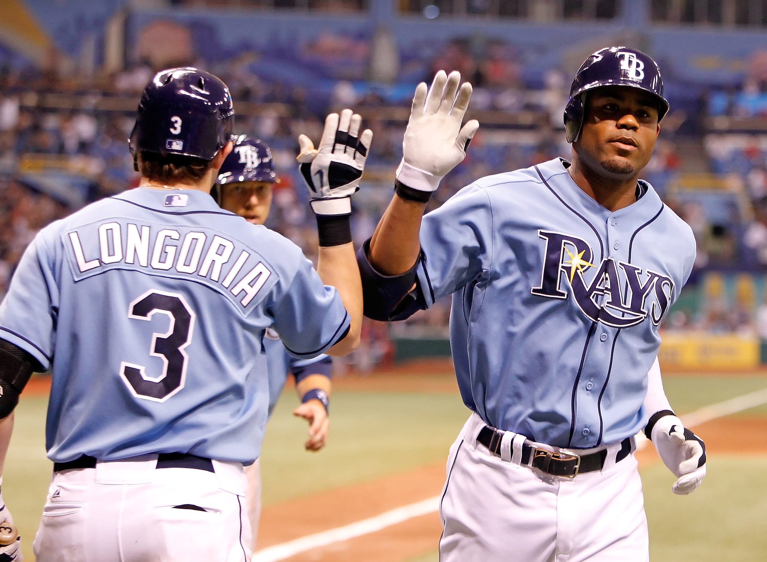 ST. PETERSBURG - AUGUST 29: Outfielder Carl Crawford #13 (right) of the Tampa Bay Rays is congratulated by Evan Longoria #3 after his home run against the Boston Red Sox during the game at Tropicana Field on August 29, 2010 in St. Petersburg, Florida. ( ST. PETERSBURG - AUGUST 29: Outfielder Carl Crawford #13 (right) of the Tampa Bay Rays is congratulated by Evan Longoria #3 after his home run against the Boston Red Sox during the game at Tropicana Field on August 29, 2010 in St. Petersburg, Florida. (
