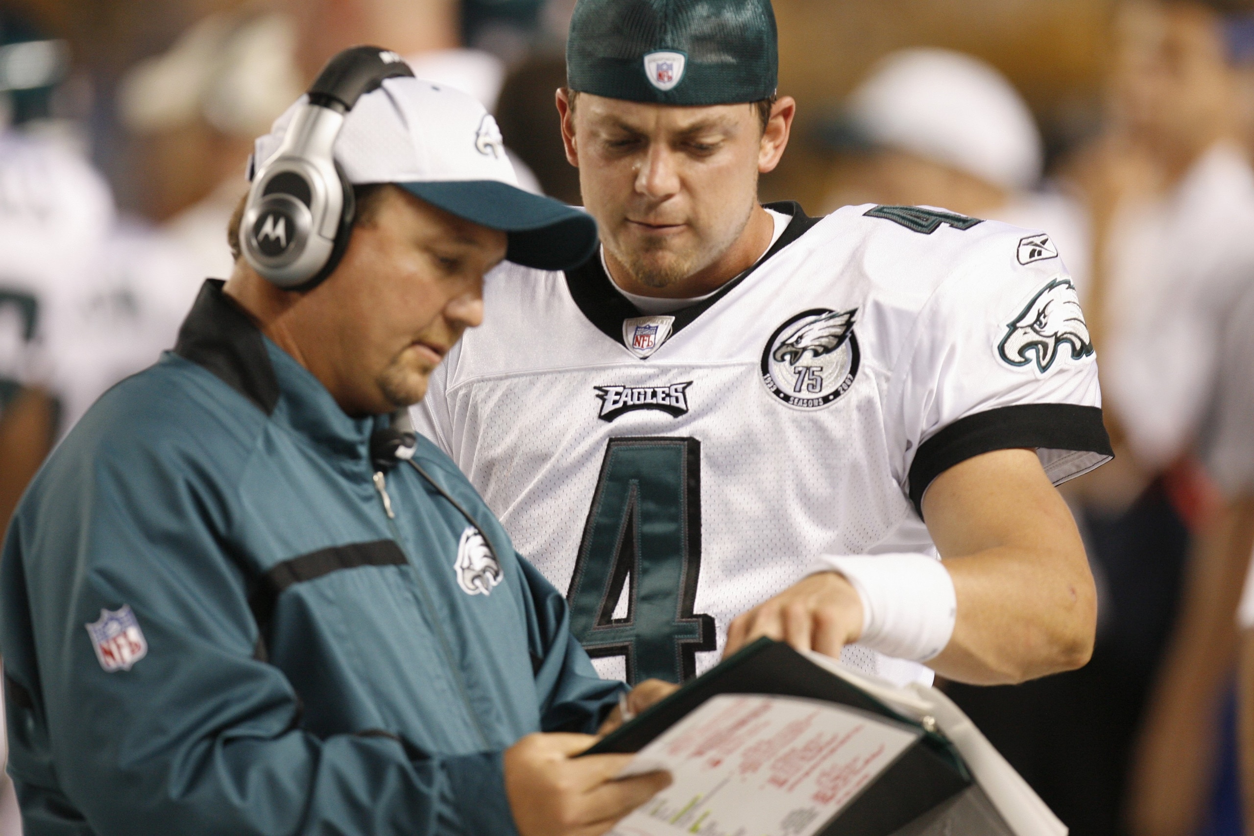PITTSBURGH - AUGUST 26:  Quarterback Kevin Kolb #4 of the Philadelphia Eagles discusses a play with Assistant Head Coach and Offensive Coordinator Marty Mornhinweg on the sidelines of the NFL preseason game against the Pittsburgh Steelerson August 26, 200