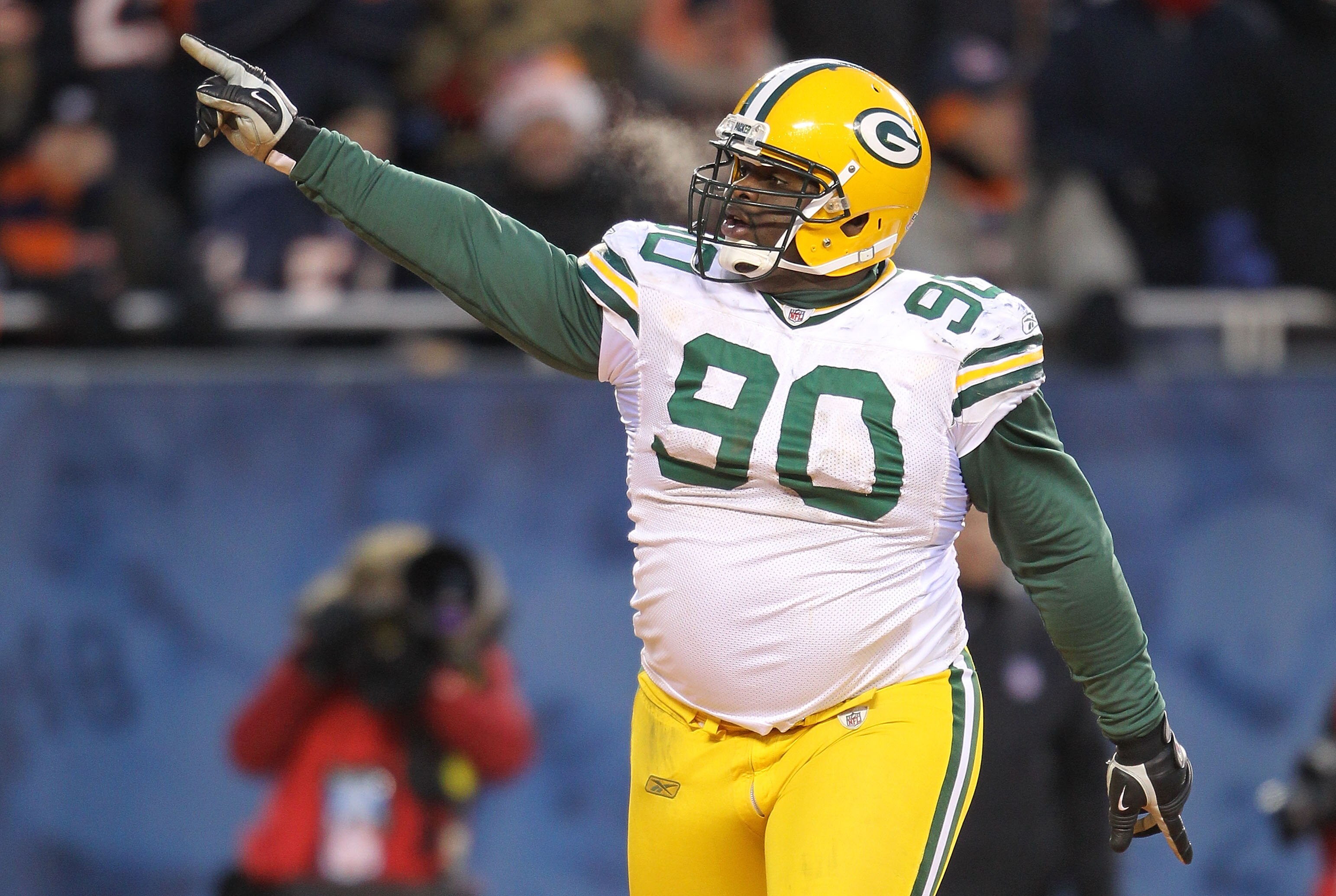CHICAGO, IL - JANUARY 23:  B.J. Raji #90 of the Green Bay Packers reacts after scoring on a 18-yard interception return for a touchdown in the fourth quarter against the Chicago Bears in the NFC Championship Game at Soldier Field on January 23, 2011 in Ch