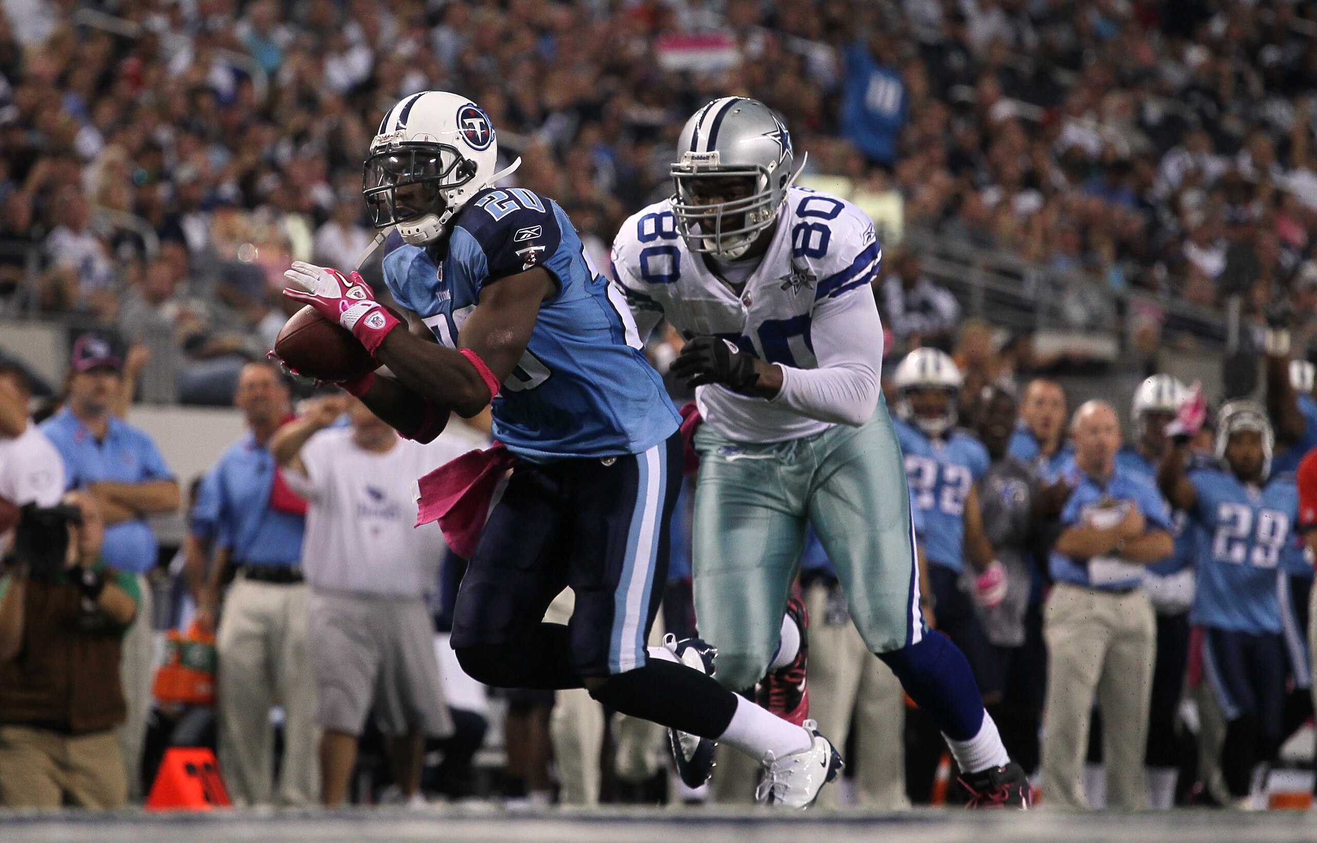 ARLINGTON, TX - OCTOBER 10: Cornerback Alterraun Verner #20 of the Tennessee Titans returns his intercepton to the one yard line in front of tight end Martellus Bennett #80 of the Dallas Cowboys at Cowboys Stadium on October 10, 2010 in Arlington, Texas.
