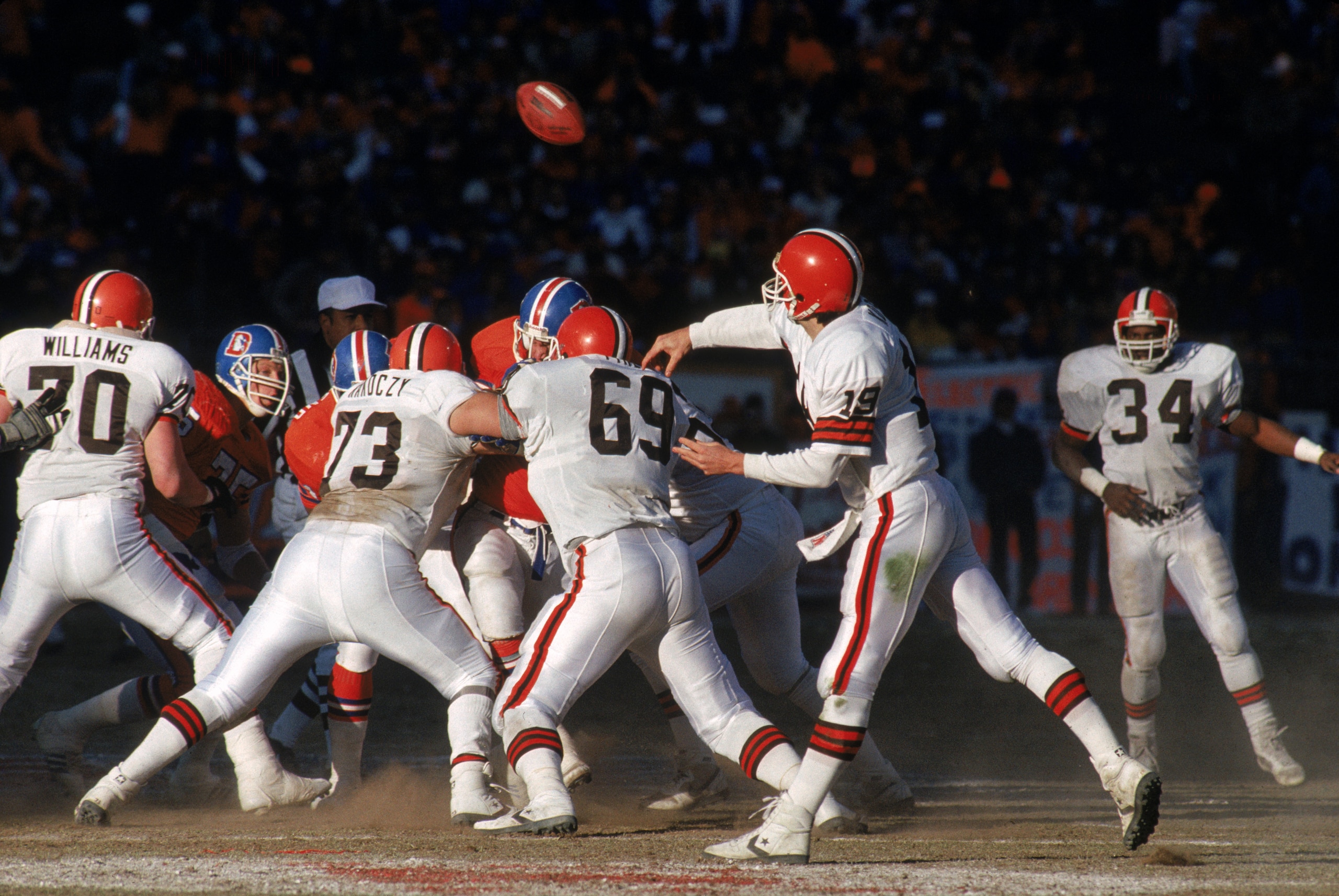 DENVER - JANUARY 17:  Quarterback Bernie Kosar #19 of the Cleveland Browns releases the ball behind strong protection during the 1987 AFC Championship game against the Denver Broncos at Mile High Stadium on January 17, 1988 in Denver, Colorado.  The Bronc