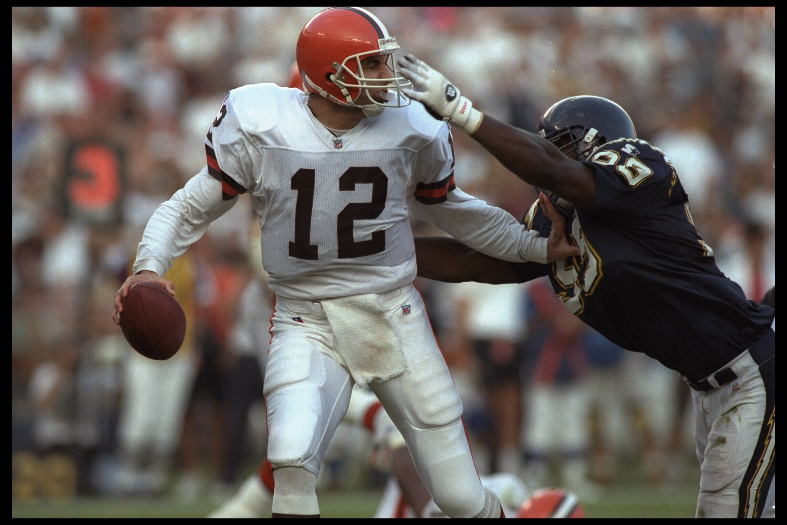 3 Dec 1995:  Quarterback Vinny Testaverde #12 of the Cleveland Browns drops back but is about to be sacked by defensive end Raylee Johnson #99 of the San Diego Chargers in this AFC match up at Jack Murphy Stadium in San Diego, California.  The Chargers de