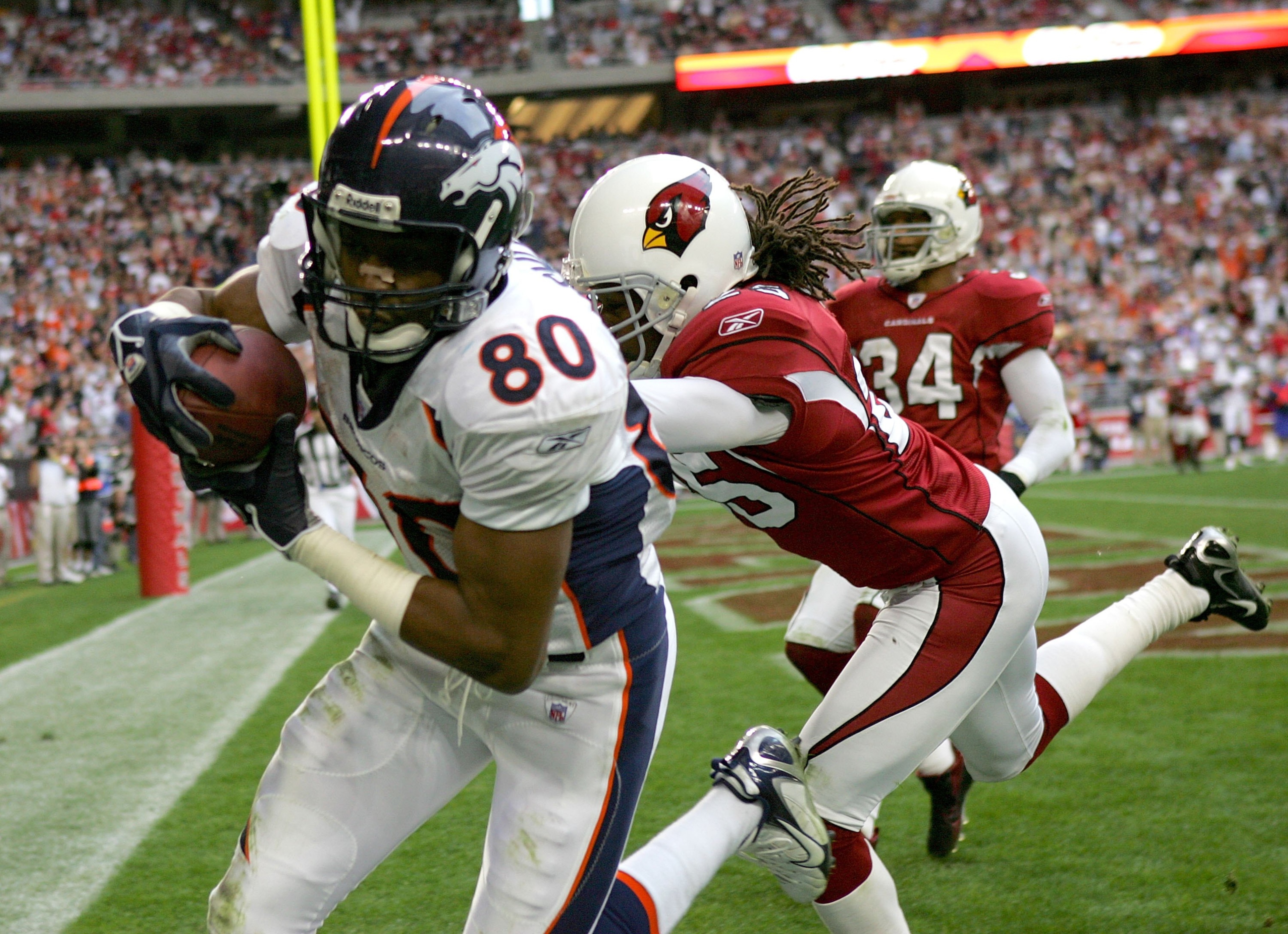 GLENDALE, AZ - DECEMBER 17: Wide receiver Rod Smith #80 of the Denver Broncos makes a touchdown catch in front of Eric Green #25 of the Arizona Cardinals on December 17, 2006 at University of Phoenix Stadium in Glendale, Arizona. The Broncos won 37-20. GLENDALE, AZ - DECEMBER 17: Wide receiver Rod Smith #80 of the Denver Broncos makes a touchdown catch in front of Eric Green #25 of the Arizona Cardinals on December 17, 2006 at University of Phoenix Stadium in Glendale, Arizona. The Broncos won 37-20.