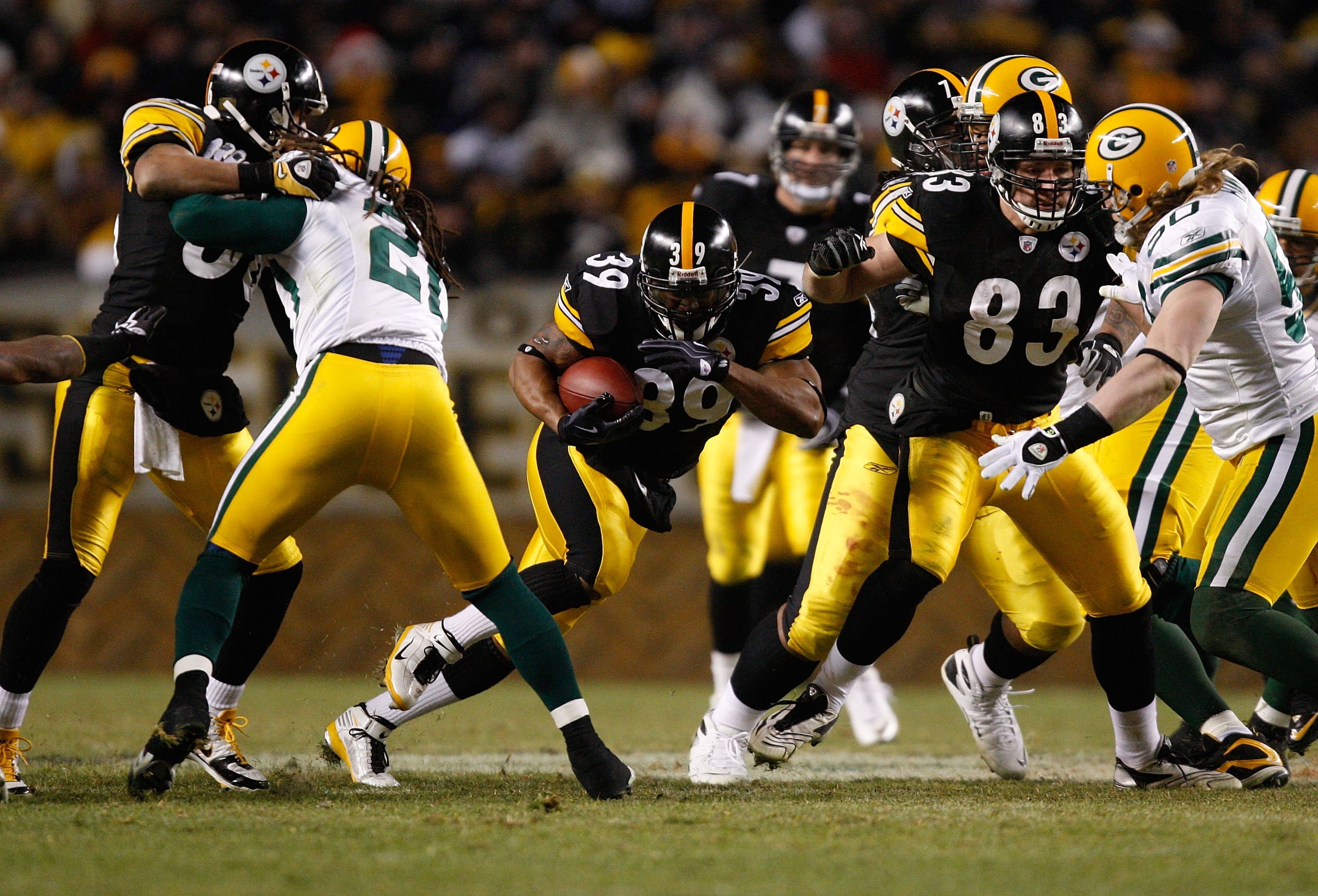 PITTSBURGH - DECEMBER 20: Willie Parker #39 of the Pittsburgh Steelers runs with the ball past Charles Woodson #21 and AJ Hawk #50 of the Green Bay Packers during the game on December 20, 2009 at Heinz Field in Pittsburgh, Pennsylvania. (Photo by Jared Wi