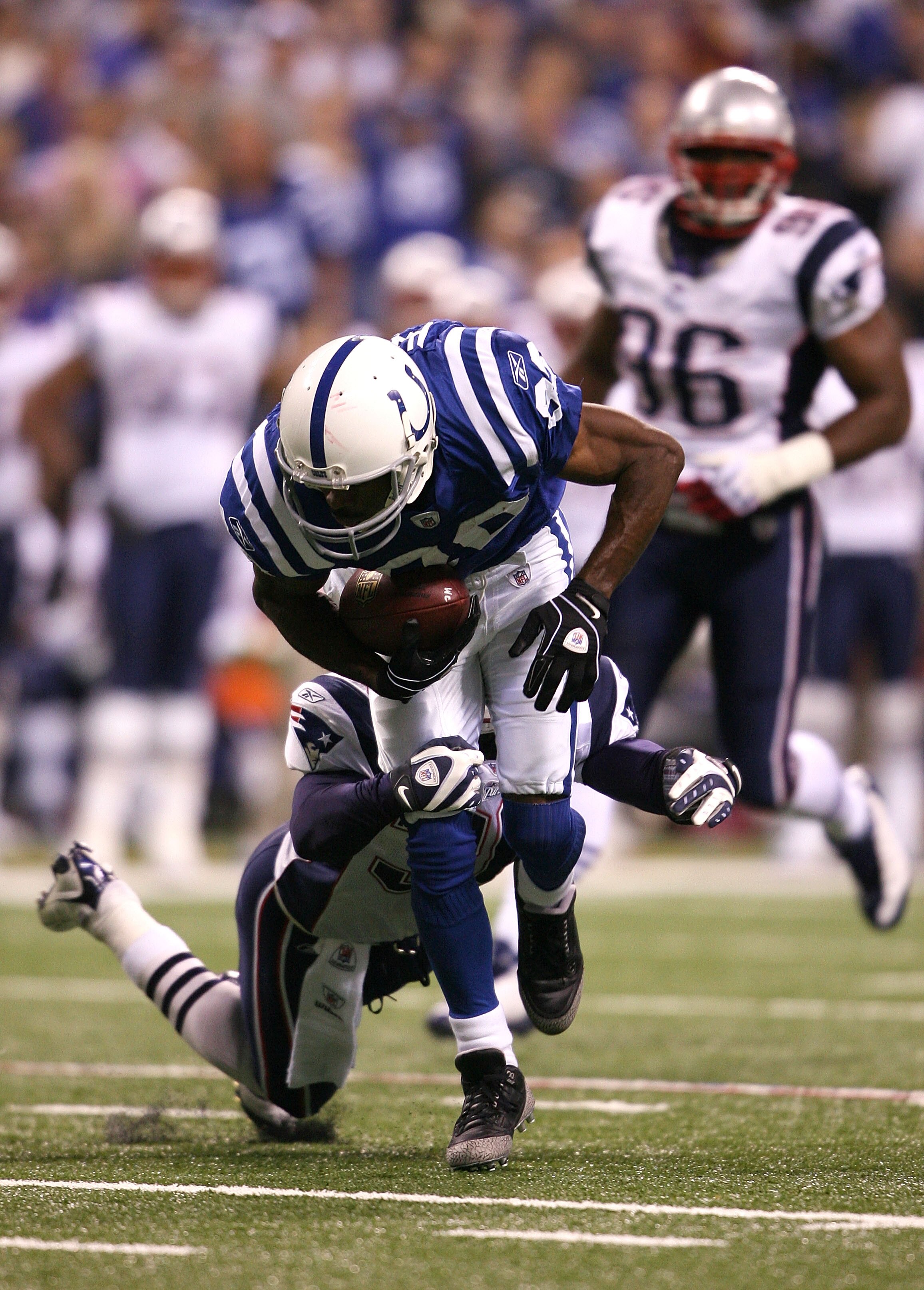 INDIANAPOLIS - NOVEMBER 02:  Marvin Harrison #88 of the Indianapolis Colts runs for yards after the catch against James Sanders #36 of the New England Patriots at Lucas Oil Stadium on November 2, 2008 in Indianapolis, Indiana.  (Photo by Andy Lyons/Getty