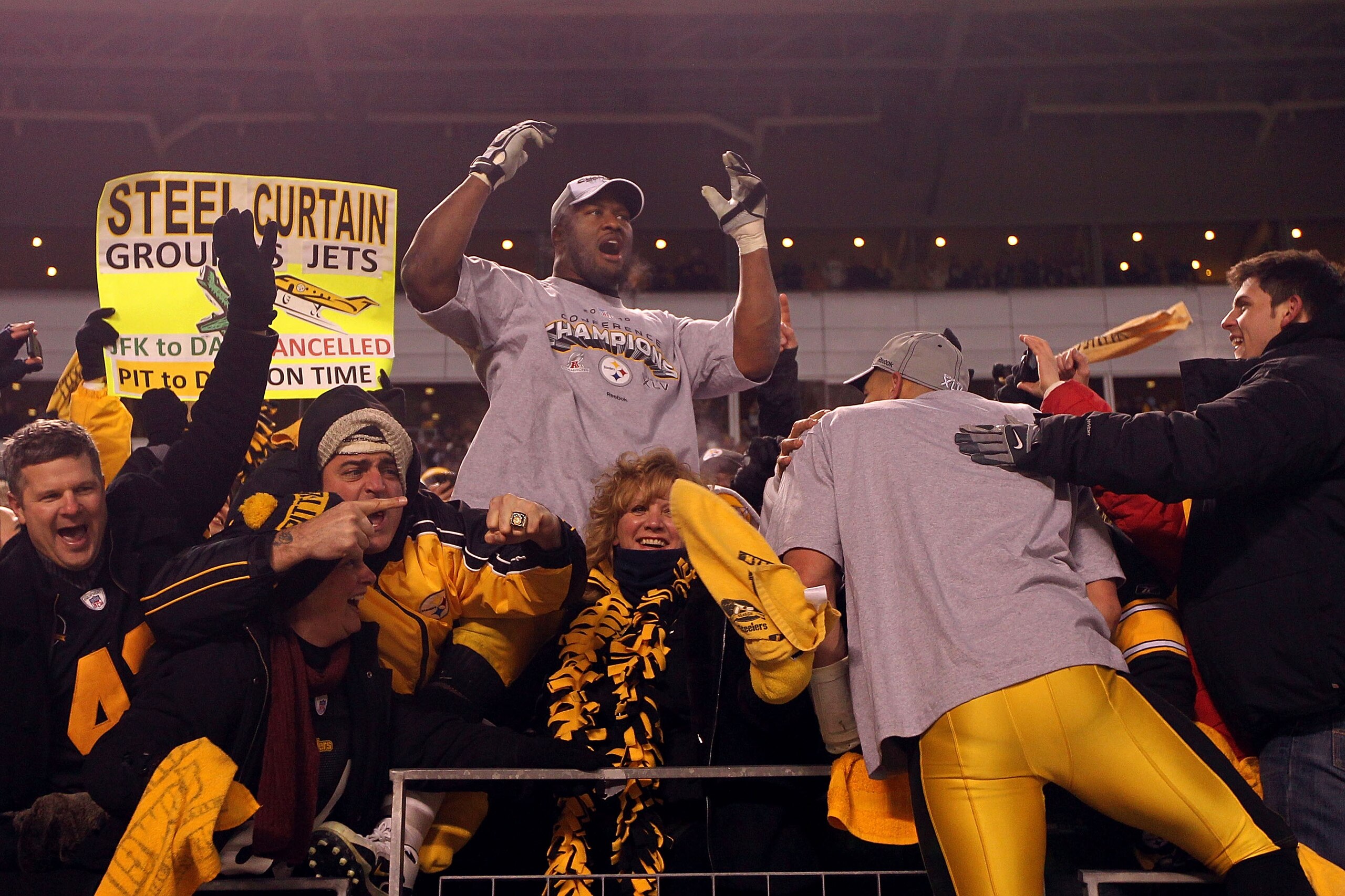 PITTSBURGH, PA - JANUARY 23:  James Harrison #92 of the Pittsburgh Steelers celebrates with fans in the stands after they defeated the New York Jets 24 to 19 in the 2011 AFC Championship game at Heinz Field on January 23, 2011 in Pittsburgh, Pennsylvania.