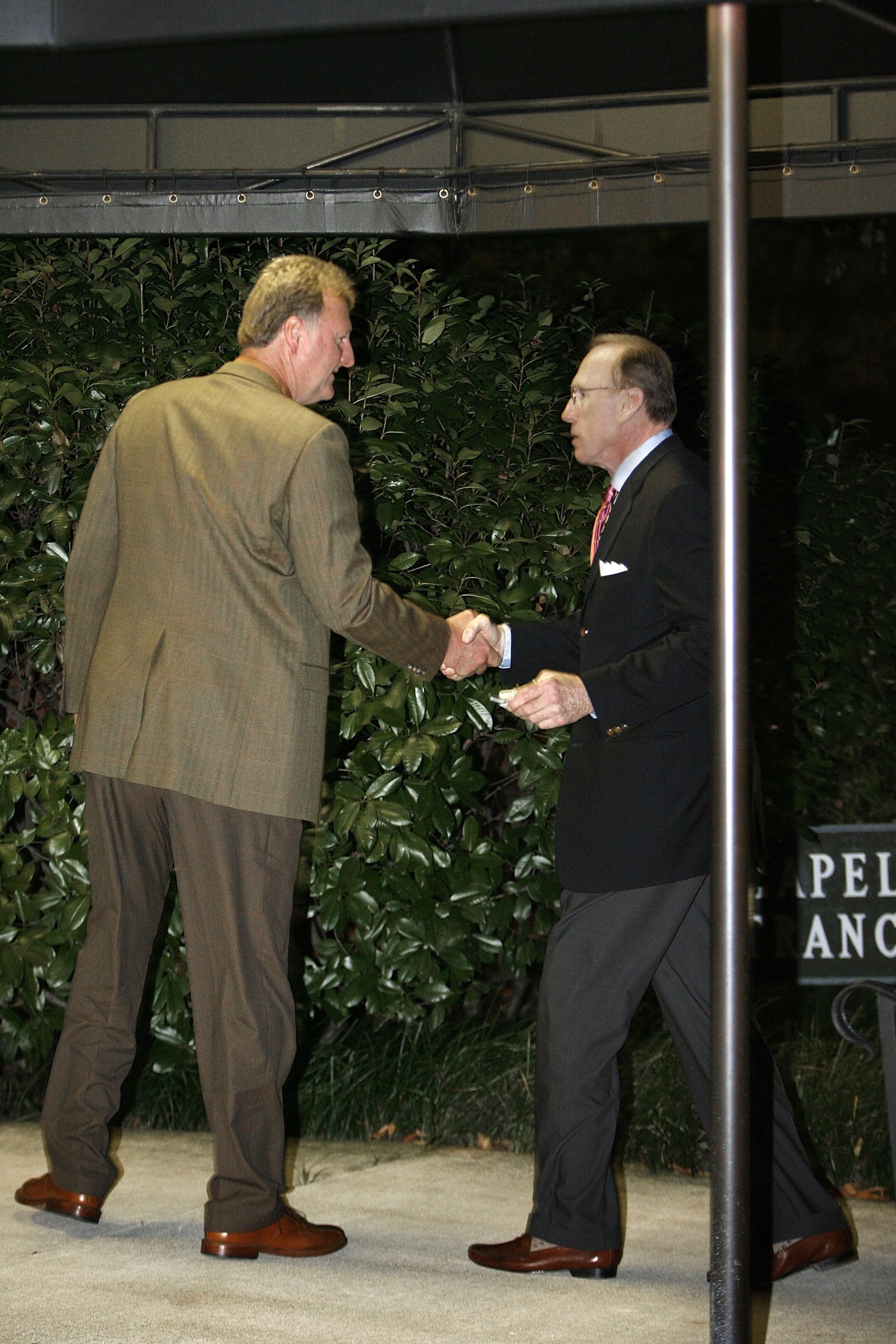 WASHINGTON - OCTOBER 30:  National Basketball Association hall of famers Larry Bird (L) and former Philadelphia 76's coach Billy Cunningham greet each other as they arrive for former Boston Celtics coach Red Auerbach's viewing at Joseph Gawler's Sons Inc.