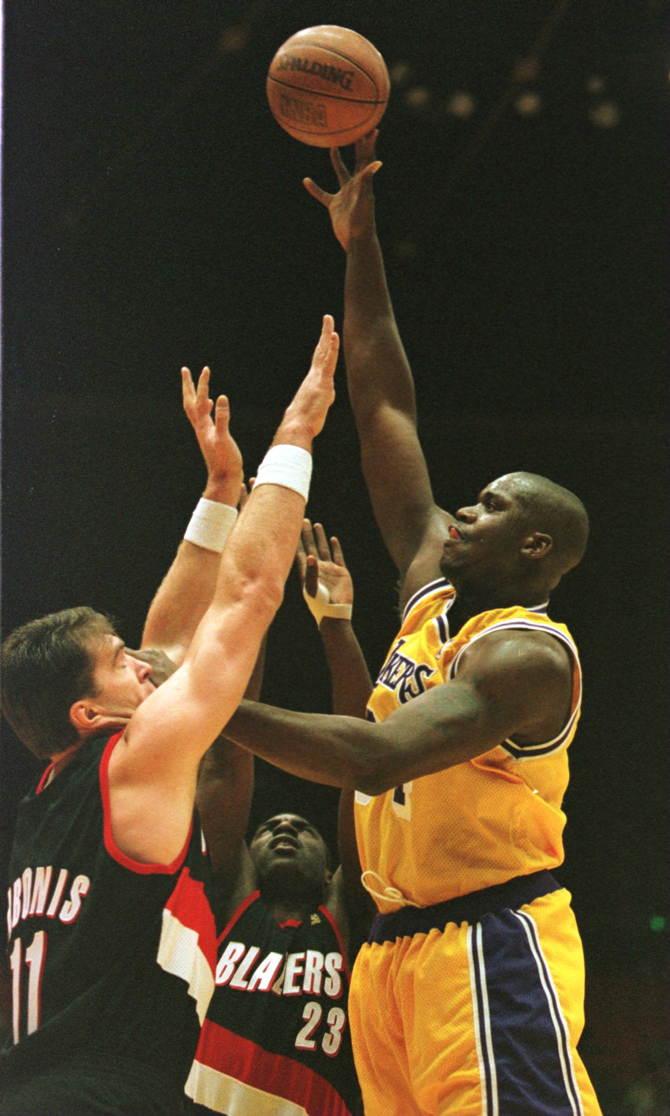 13 Dec 1996: Center Shaquille O'Neal of the Los Angeles Lakers towers over Arvydas Sabonis #11 and Aaron McKie #23 of the Portland Trailblazers as fires a shot during the first period at the Great Western Forum in Inglewood, California. +++