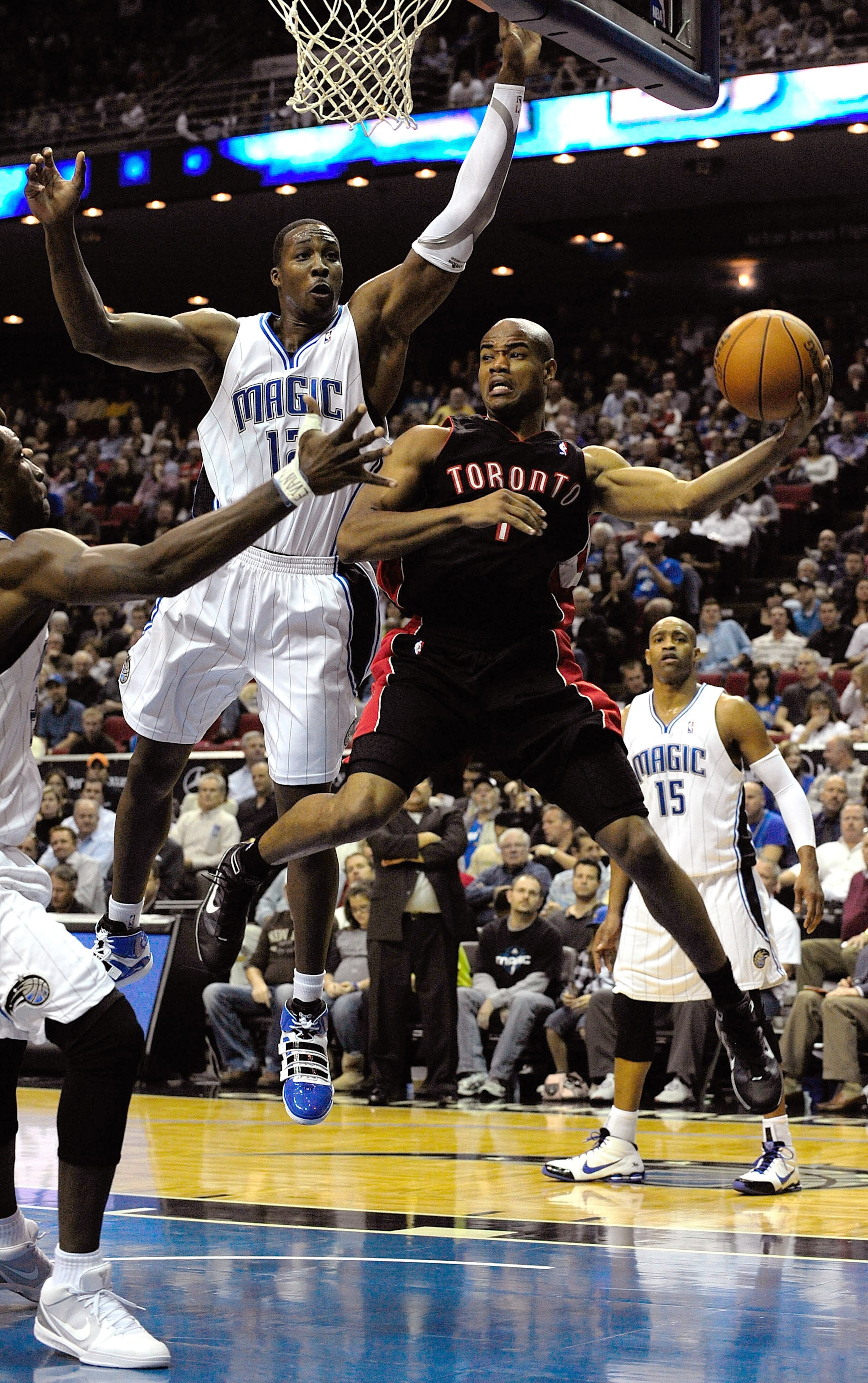 ORLANDO, FL - DECEMBER 16:  Jarrett Jack #1 of the Toronto Raptors looks to pass against Dwight Howard #12 of the Orlando Magic during the game at Amway Arena on December 16, 2009 in Orlando, Florida.  NOTE TO USER: User expressly acknowledges and agrees 