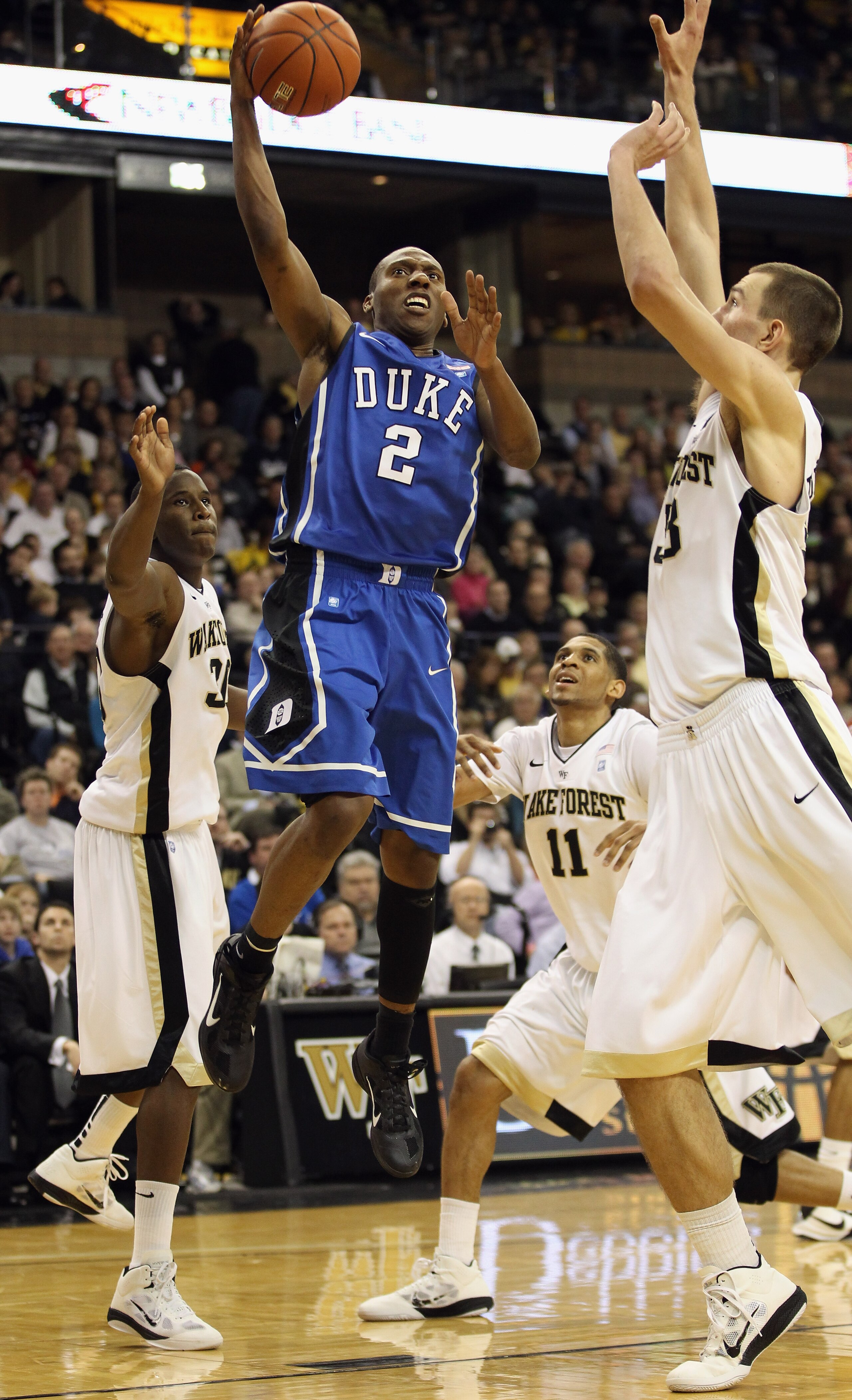 WINSTON SALEM, NC - JANUARY 22:  Nolan Smith #2 of the Duke Blue Devils drives to the basket on the defense of the Wake Forest Demon Deacons during their game at Lawrence Joel Coliseum on January 22, 2011 in Winston Salem, North Carolina.  (Photo by Stree