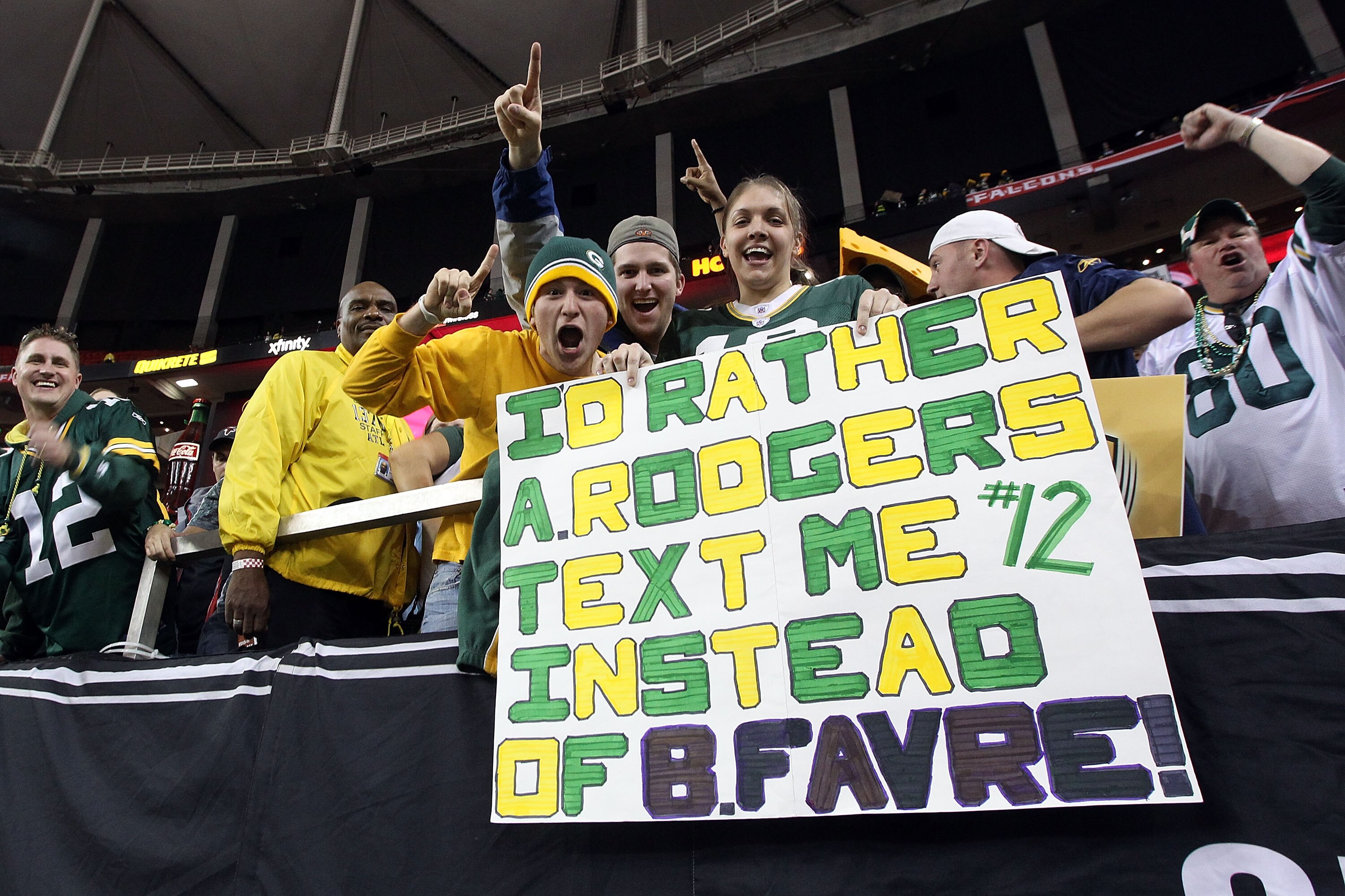ATLANTA, GA - JANUARY 15:  Fans of the Green Bay Packers hold up a sign which reads 'I'd Rather Aaron Rodgers text me instead of Brett Favre after the Packers defeated the Atlanta Falcons 48-21 during their 2011 NFC divisional playoff game at Georgia Dome