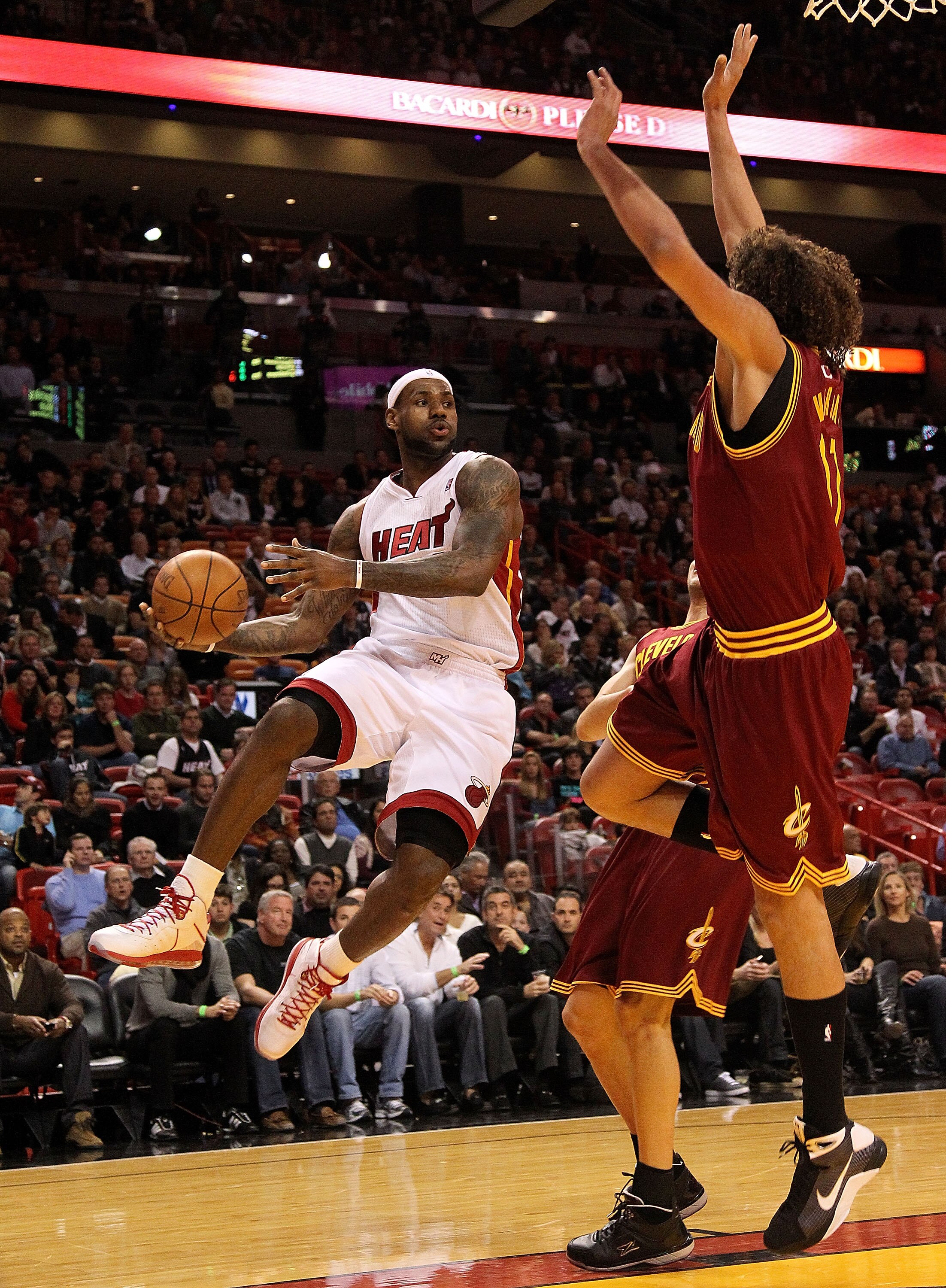 MIAMI, FL - DECEMBER 15:  LeBron James #6 of the Miami Heat passes around Anderson Varejao #17 of the Cleveland Cavaliers during a game  at American Airlines Arena on December 15, 2010 in Miami, Florida. NOTE TO USER: User expressly acknowledges and agree