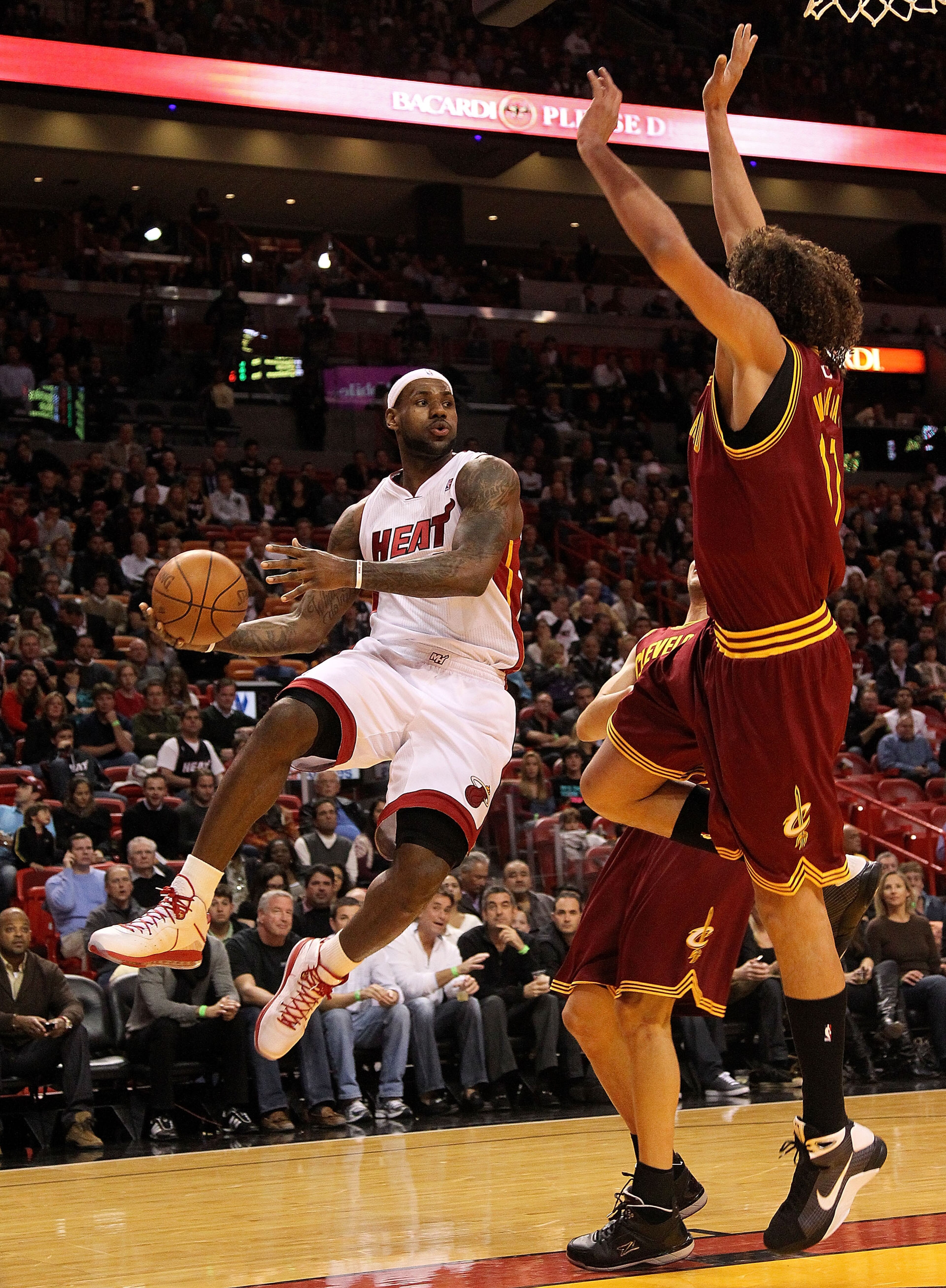 MIAMI, FL - DECEMBER 15: LeBron James #6 of the Miami Heat passes around Anderson Varejao #17 of the Cleveland Cavaliers during a game at American Airlines Arena on December 15, 2010 in Miami, Florida. NOTE TO USER: User expressly acknowledges and agree MIAMI, FL - DECEMBER 15: LeBron James #6 of the Miami Heat passes around Anderson Varejao #17 of the Cleveland Cavaliers during a game at American Airlines Arena on December 15, 2010 in Miami, Florida. NOTE TO USER: User expressly acknowledges and agree