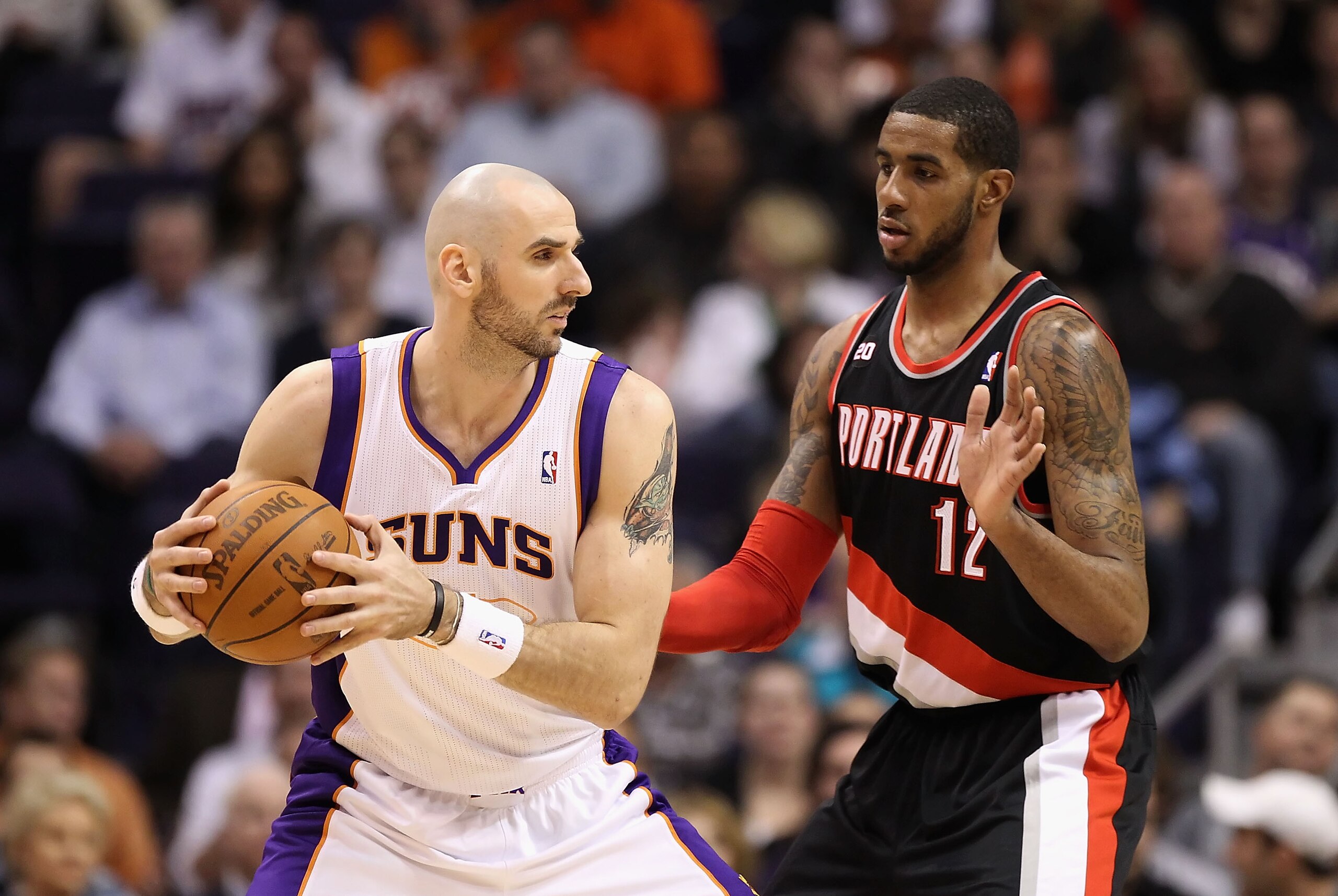PHOENIX, AZ - JANUARY 14:  Marcin Gortat #4 of the Phoenix Suns looks to pass against LaMarcus Aldridge #12 of the Portland Trail Blazers during the NBA game at US Airways Center on January 14, 2011 in Phoenix, Arizona. The Suns defeated the Trail Blazers