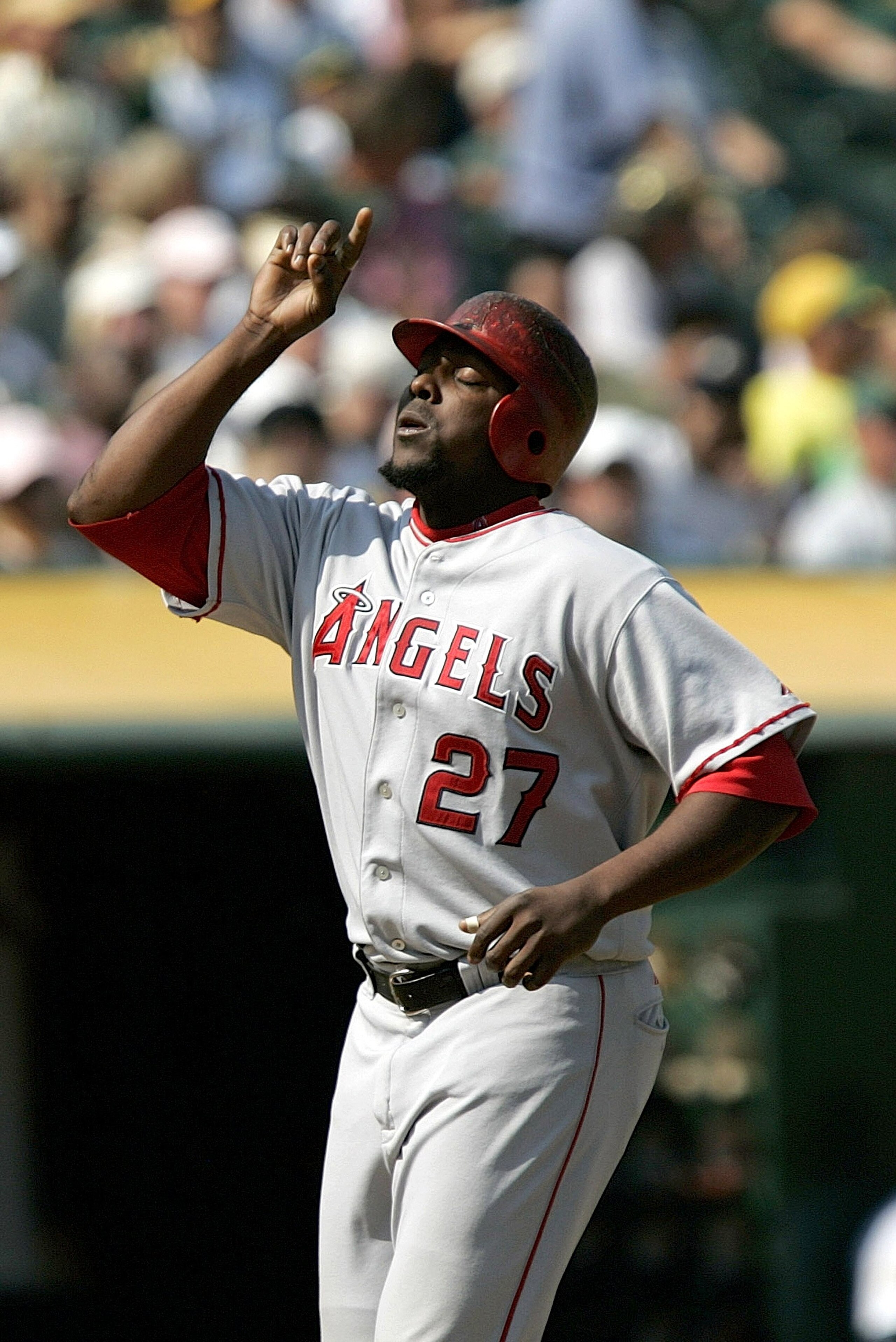 OAKLAND, CA  - SEPTEMBER 24:  Los Angeles Angles Vladimir Guerrero #27 points to the sky as he crosses home plate after hitting a 2 run homerun in the 6th inning as the Oakland A's host the Los Angeles Angeles at McAfee Coliseum on September 24, 2006 in O