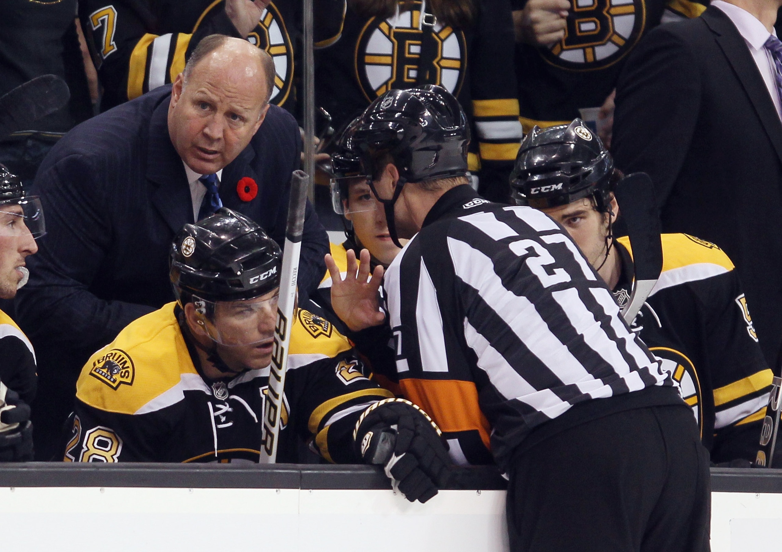 BOSTON - NOVEMBER 06: Head coach Claude Julien of the Boston Bruins speaks with referee Craig Furlatt #27 after a goal in the second period by the Bruins was reviewed and cancelled against the St. Louis Blues on November 6, 2010 at the TD Garden in Boston