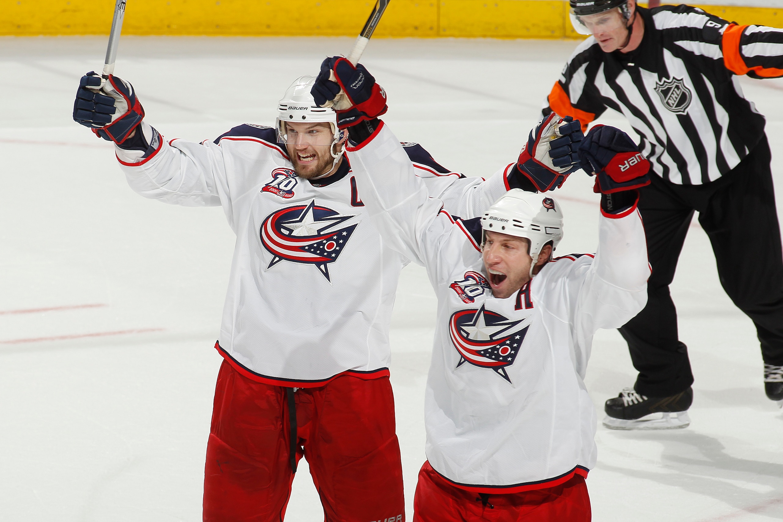 SUNRISE, FL - JANUARY 19: RJ Umberger #18 (R) and Rick Nash #61 of the Columbus Blue Jackets raise their sticks and celebrate Nash's winning goal against the Florida Panthers on January 19, 2011 at the BankAtlantic Center in Sunrise, Florida. The Blue Jac