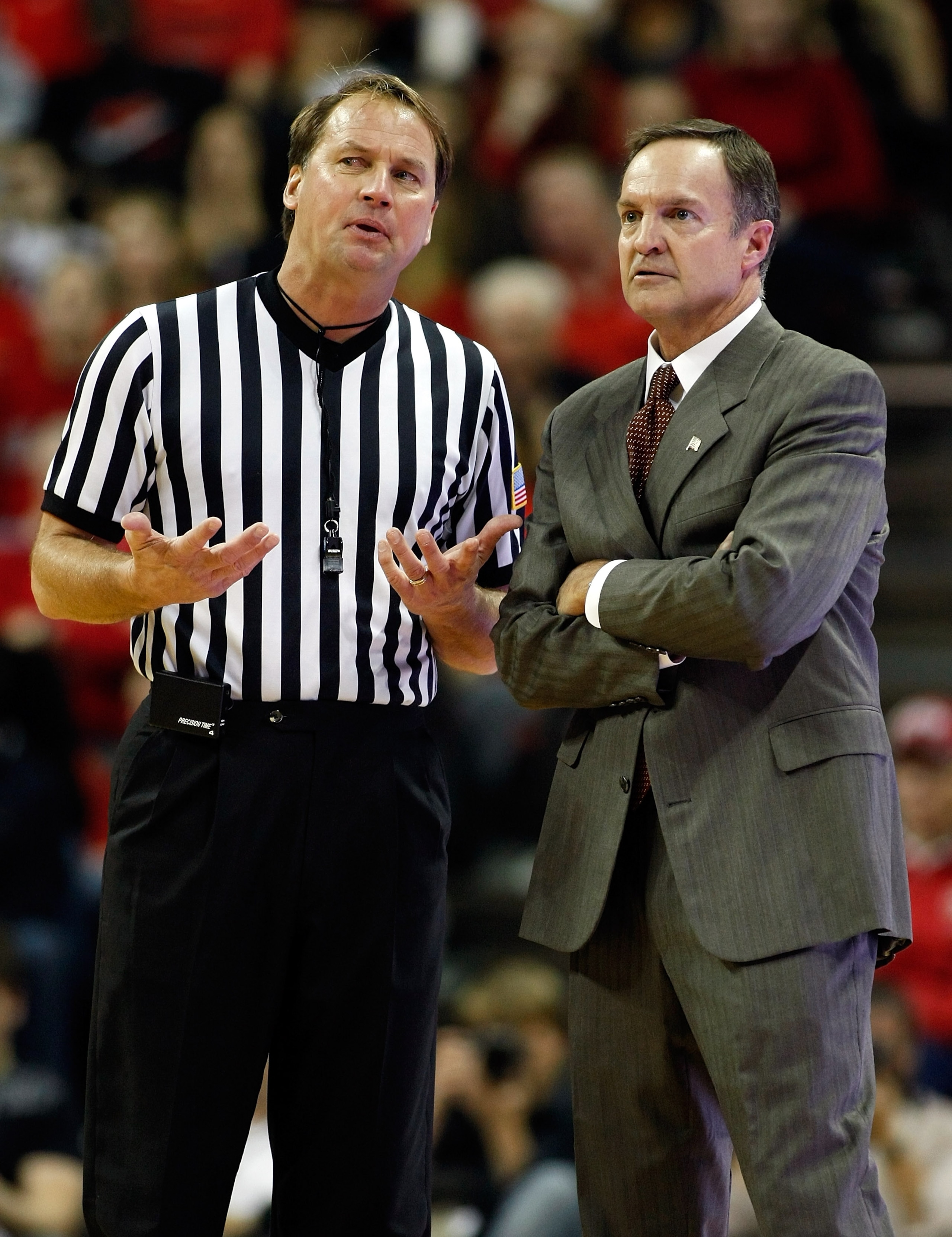 LAS VEGAS, NV - JANUARY 05:  Referee John Higgins (L) talks to head coach Lon Kruger of the UNLV Rebels during the team's game against the Brigham Young University Cougars at the Thomas & Mack Center January 5, 2011 in Las Vegas, Nevada. BYU won 89-77.  (
