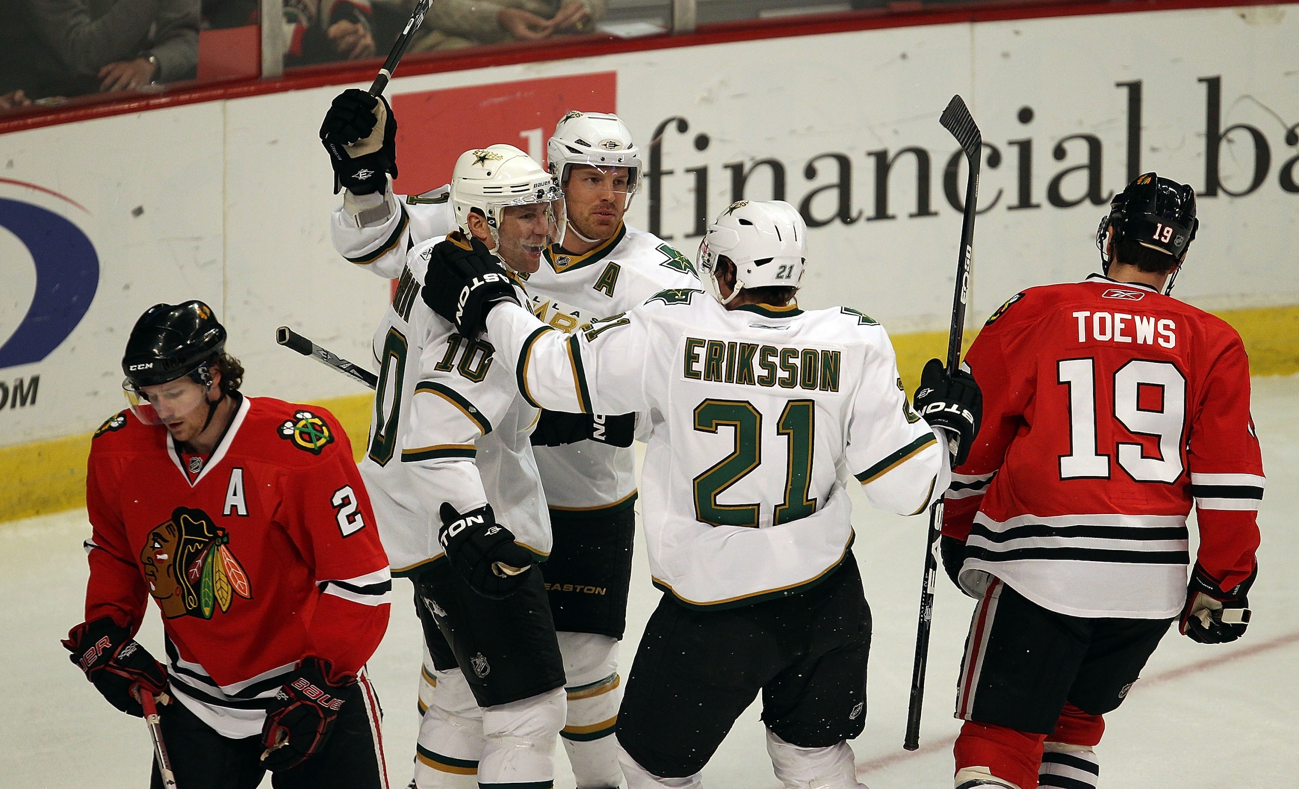 CHICAGO, IL - JANUARY 05: (L-R) Brenden Morrow #10, Brad Richards #91 and Loui Eriksson #21 of the Dallas Stars celebrate Morrows' 1st period goal as Duncan Kieth #2 and Jonathan Toews #19 of the Chicago Blackhawks skate away at the United Center on Janua