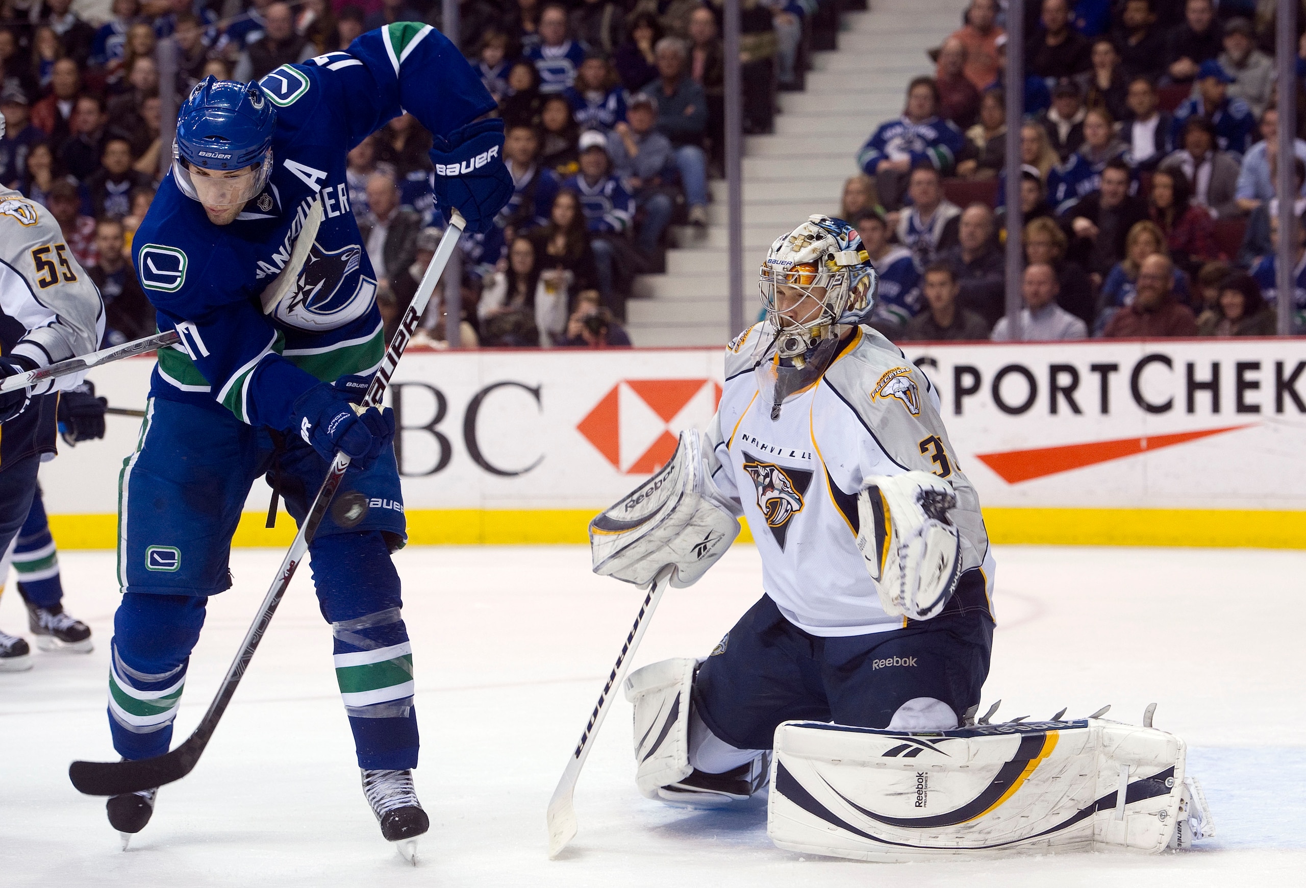 VANCOUVER, CANADA - JANUARY 26: Ryan Kesler #17 of the Vancouver Canucks tries to redirect the puck past goalie Pekka Rinne #35 of the Nashville Predators during the second period in NHL action on January 26, 2011 at Rogers Arena in Vancouver, British Col