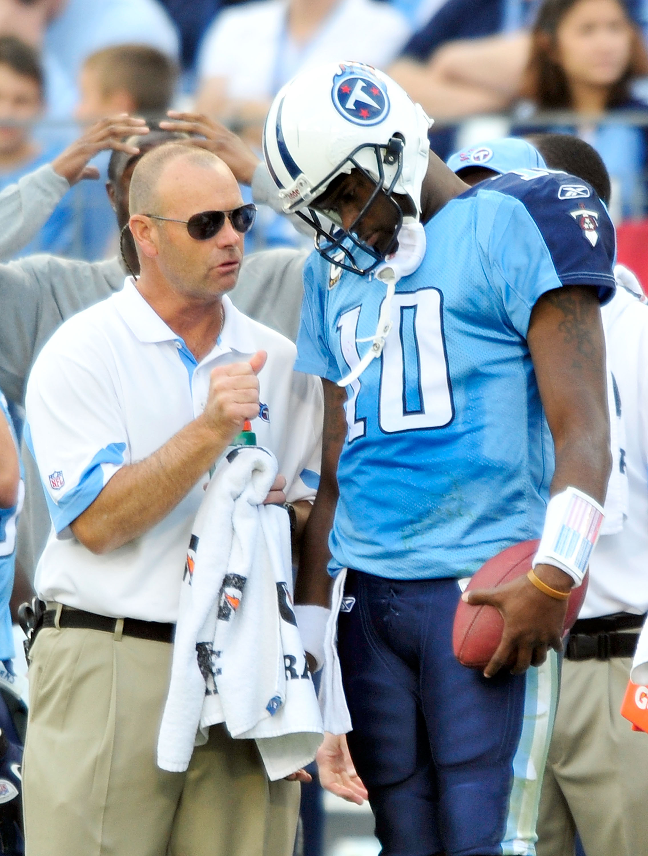 NASHVILLE, TN - NOVEMBER 21: Quarterback Vince Young #11 of the Tennessee Titans talks with a member of the training staff after leaving a game against the Washington Redskins at LP Field on November 21, 2010 in Nashville, Tennessee. The Redskins won 19-