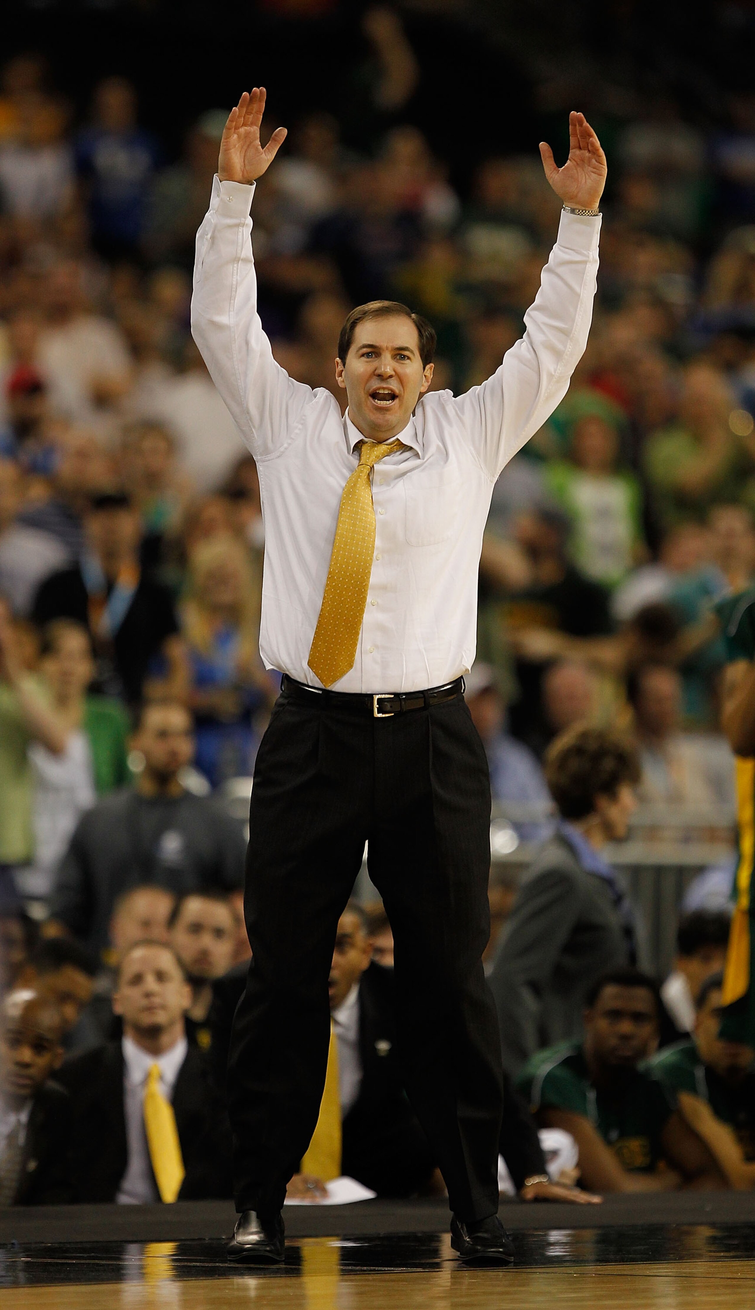 HOUSTON - MARCH 28: Head coach Scott Drew of the Baylor Bears encourages the crowd during a game against the Duke Blue Devils in the south regional final of the 2010 NCAA men's basketball tournament at Reliant Stadium on March 28, 2010 in Houston, Texas.
