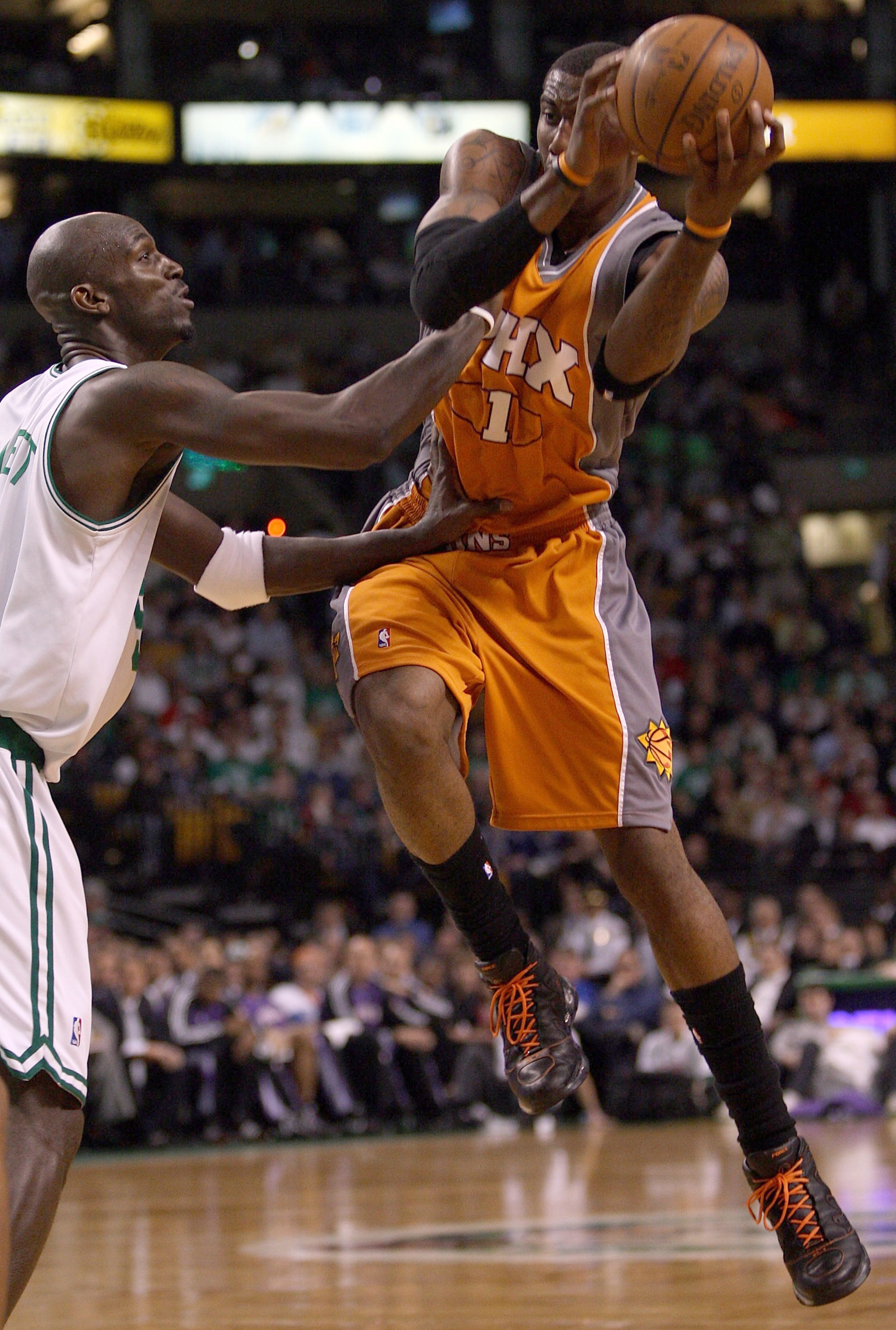 BOSTON - MARCH 26:  Kevin Garnett #5 of the Boston Celtics is unable to nab the loose ball as Amare Stoudemire #1 of the Phoenix Suns catches it on March 26, 2008 at the TD Banknorth Garden in Boston, Massachusetts. The Celtics defeated the Suns 117-97. N