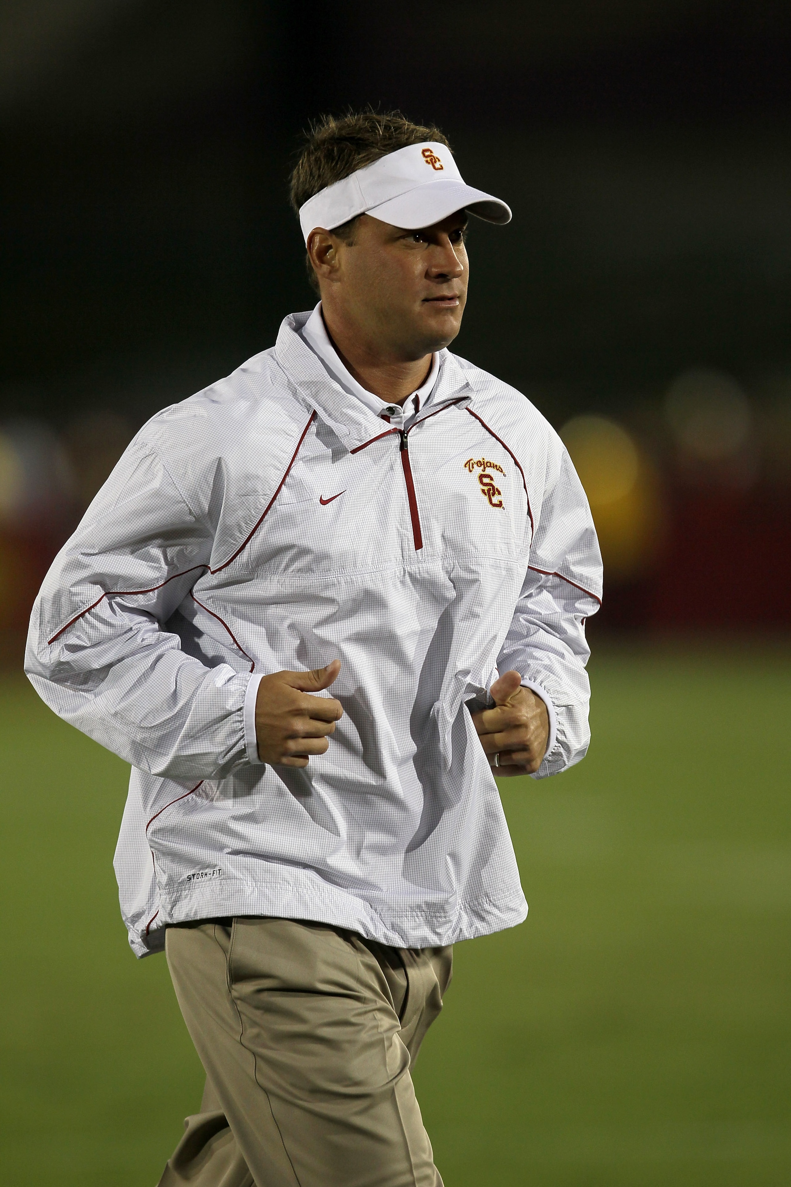 LOS ANGELES, CA - SEPTEMBER 11:  Head coach Lane Kiffin of the USC Trojans runs off the field after warmups for their game with the Virginia Cavaliers at Los Angeles Memorial Coliseum on September 11, 2010 in Los Angeles, California.  (Photo by Stephen Du