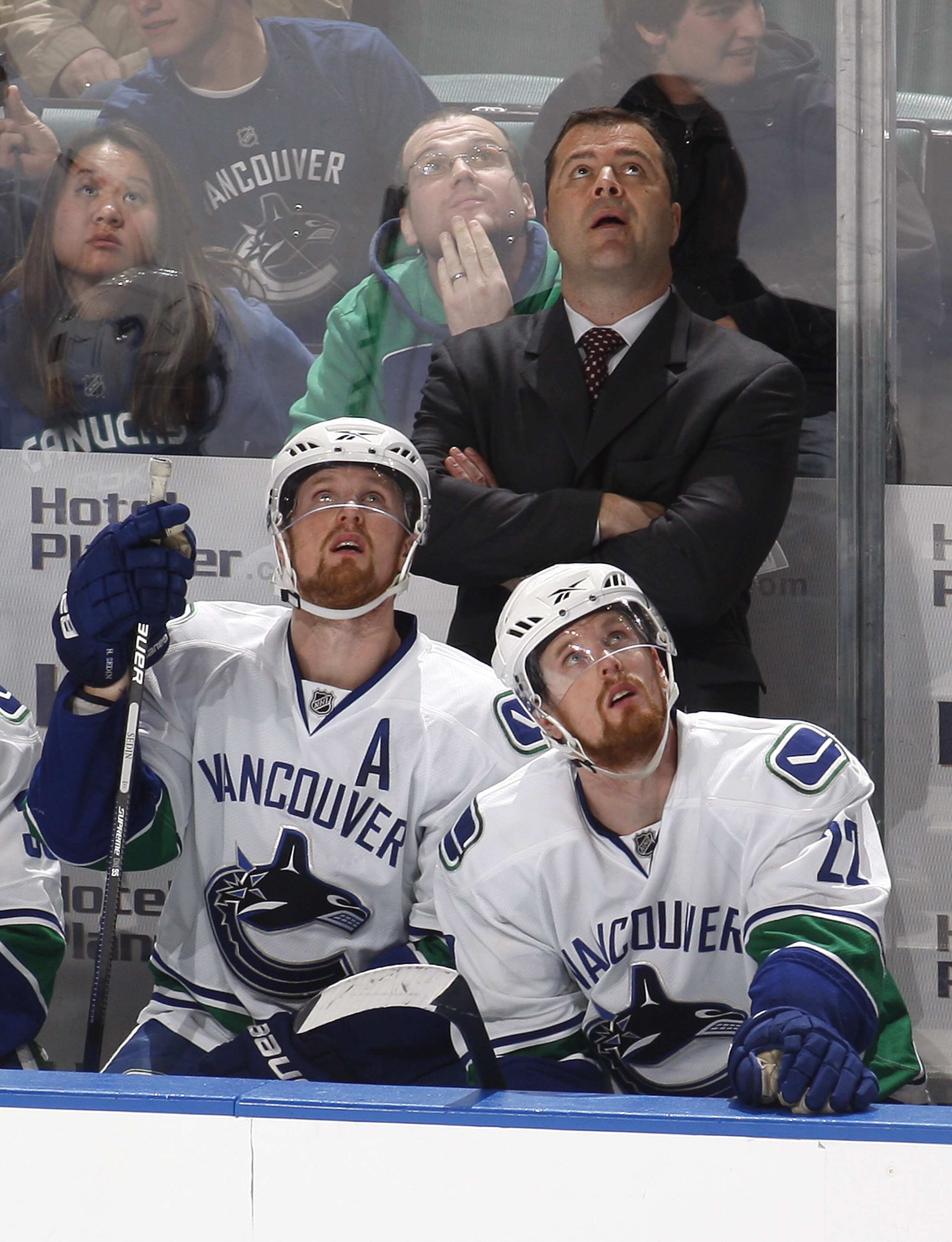 SUNRISE, FL - FEBRUARY 11: Head coach Alain Vigneault, Henrik Sedin #33 and Daniel Sedin #22 of the Vancouver Canucks watch a replay during a time out late in the third period of the game against the Florida Panthers on February 11, 2010 at the BankAtlant