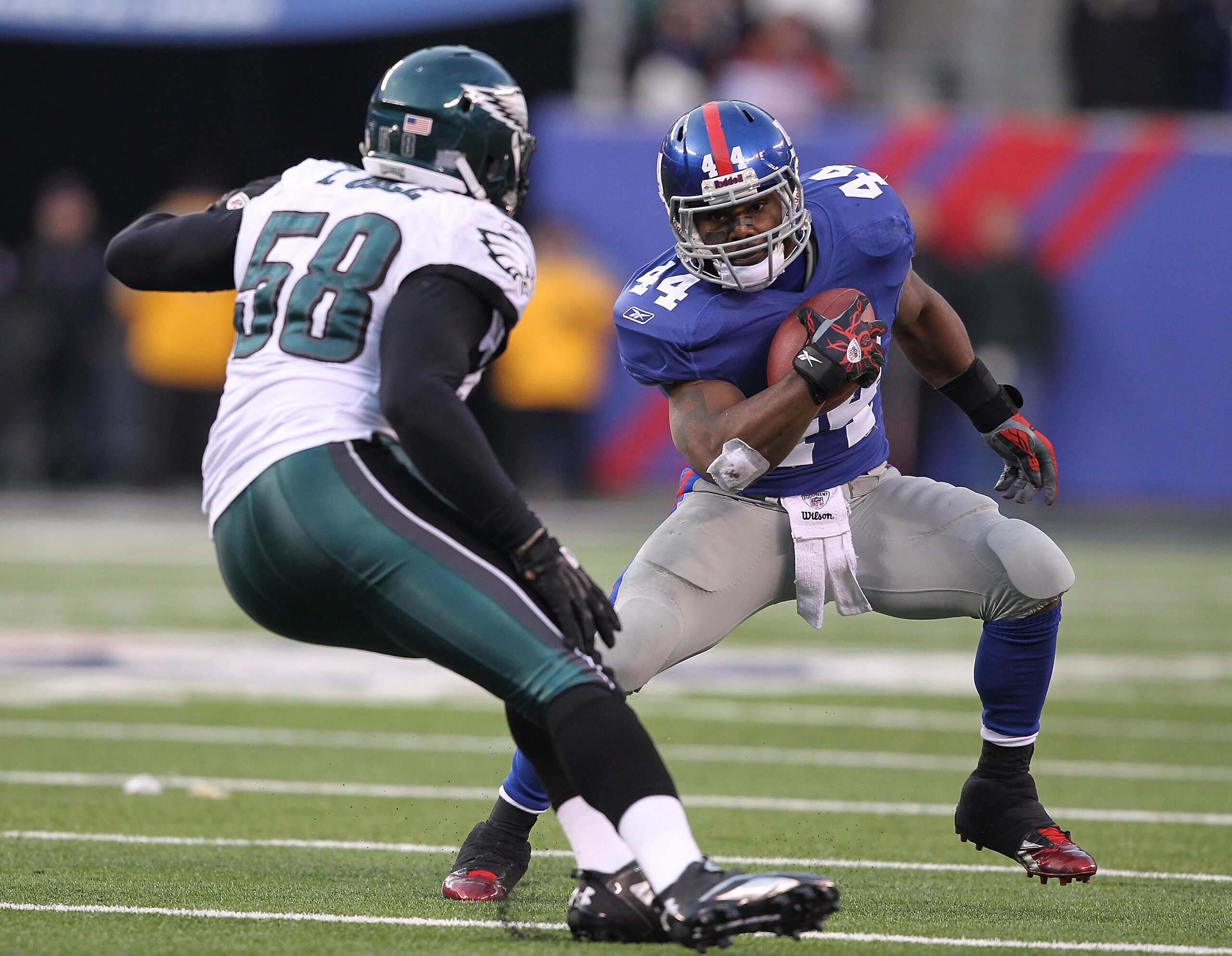 EAST RUTHERFORD, NJ - DECEMBER 19: Ahmad Bradshaw #44 of the New York Giants runs with the ball as Trent Cole #58 of the Philadelphia Eagles defends during their game on December 19, 2010 at The New Meadowlands Stadium in East Rutherford, New Jersey. (P EAST RUTHERFORD, NJ - DECEMBER 19: Ahmad Bradshaw #44 of the New York Giants runs with the ball as Trent Cole #58 of the Philadelphia Eagles defends during their game on December 19, 2010 at The New Meadowlands Stadium in East Rutherford, New Jersey. (P