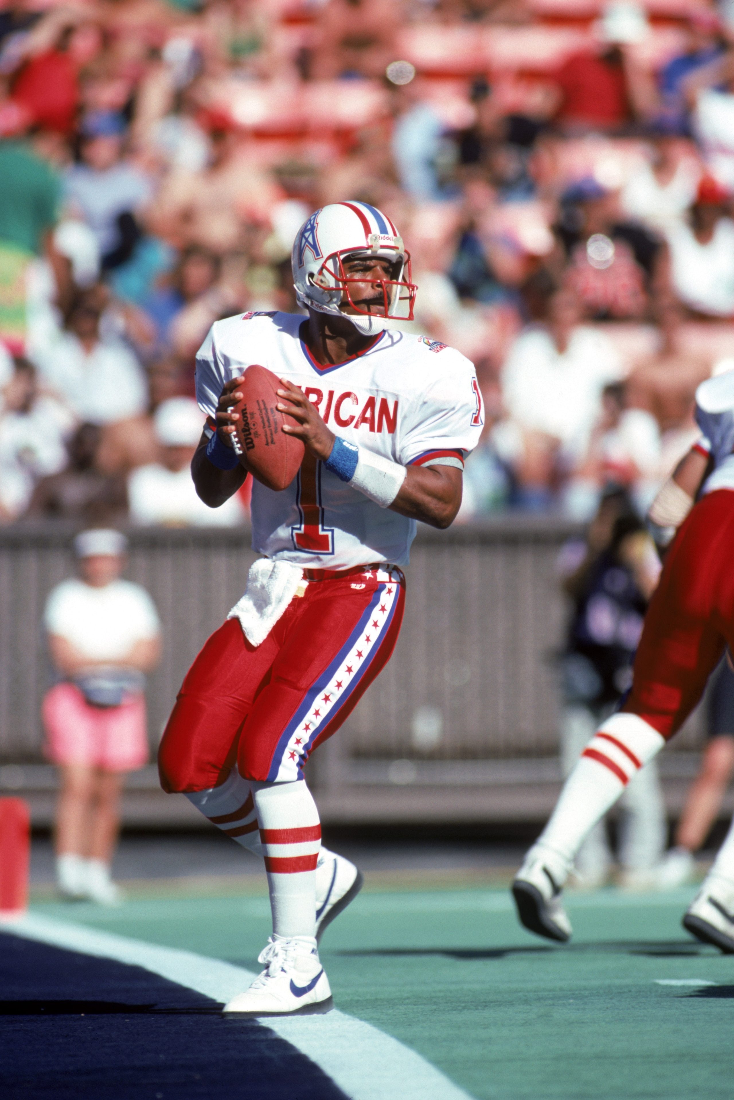 HONOLULU, HI - FEBRUARY 4:  Houston Oilers quarterback Warren Moon #1 of the AFC squad drops back to pass during the 1990 NFL Pro Bowl at Aloha Stadium on February 4, 1990 in Honolulu, Hawaii.  The NFC won 27-21.  (Photo by George Rose/Getty Images)