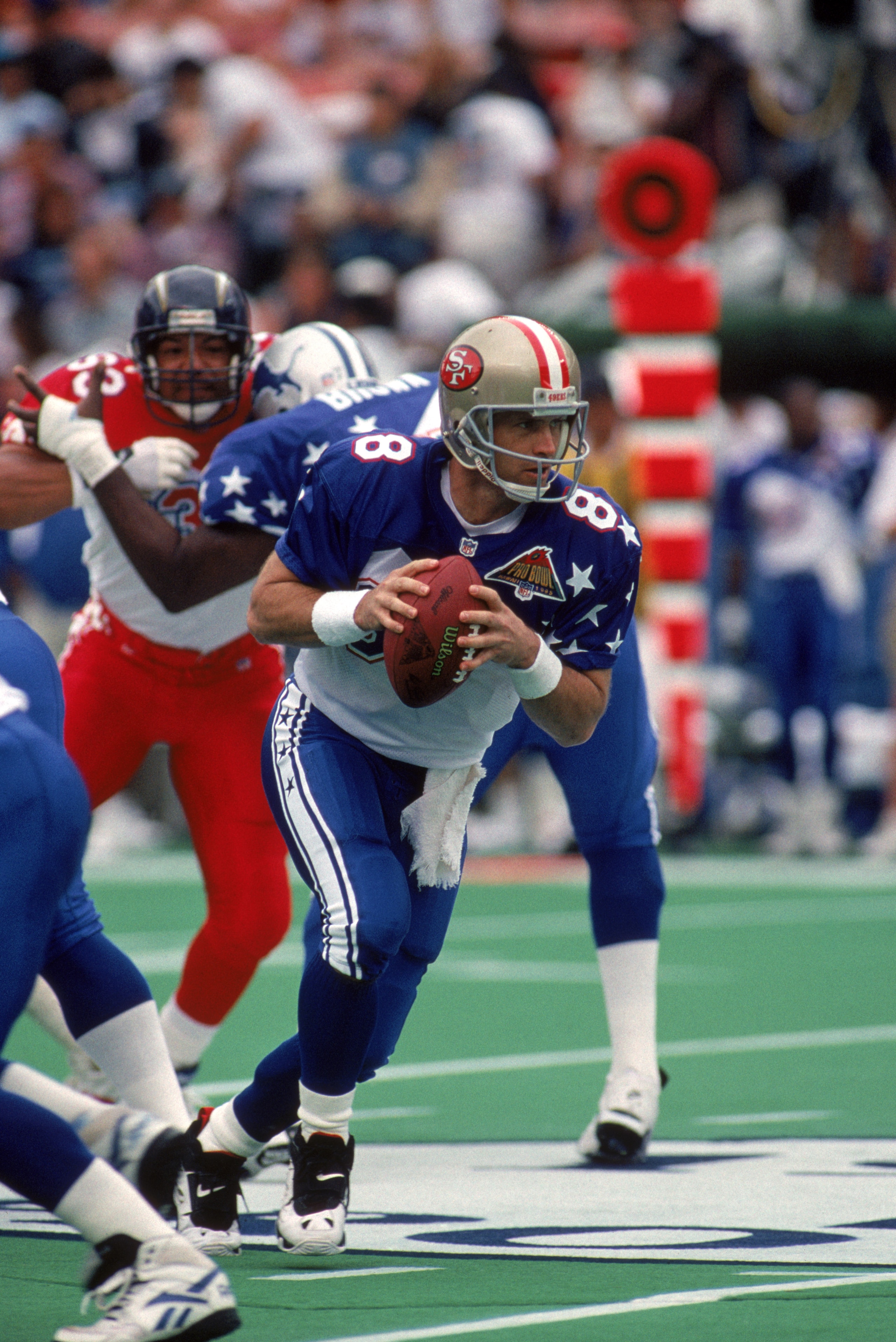 HONOLULU, HI - FEBRUARY 5:  San Francisco 49ers quarterback Steve Young #8 of the NFC Team runs a play during the 1995 NFL Pro Bowl at Aloha Stadium on February 5, 1995 in Honolulu, Hawaii.  The AFC defeated the NFC 41-13.  (Photo by George Rose/Getty Ima