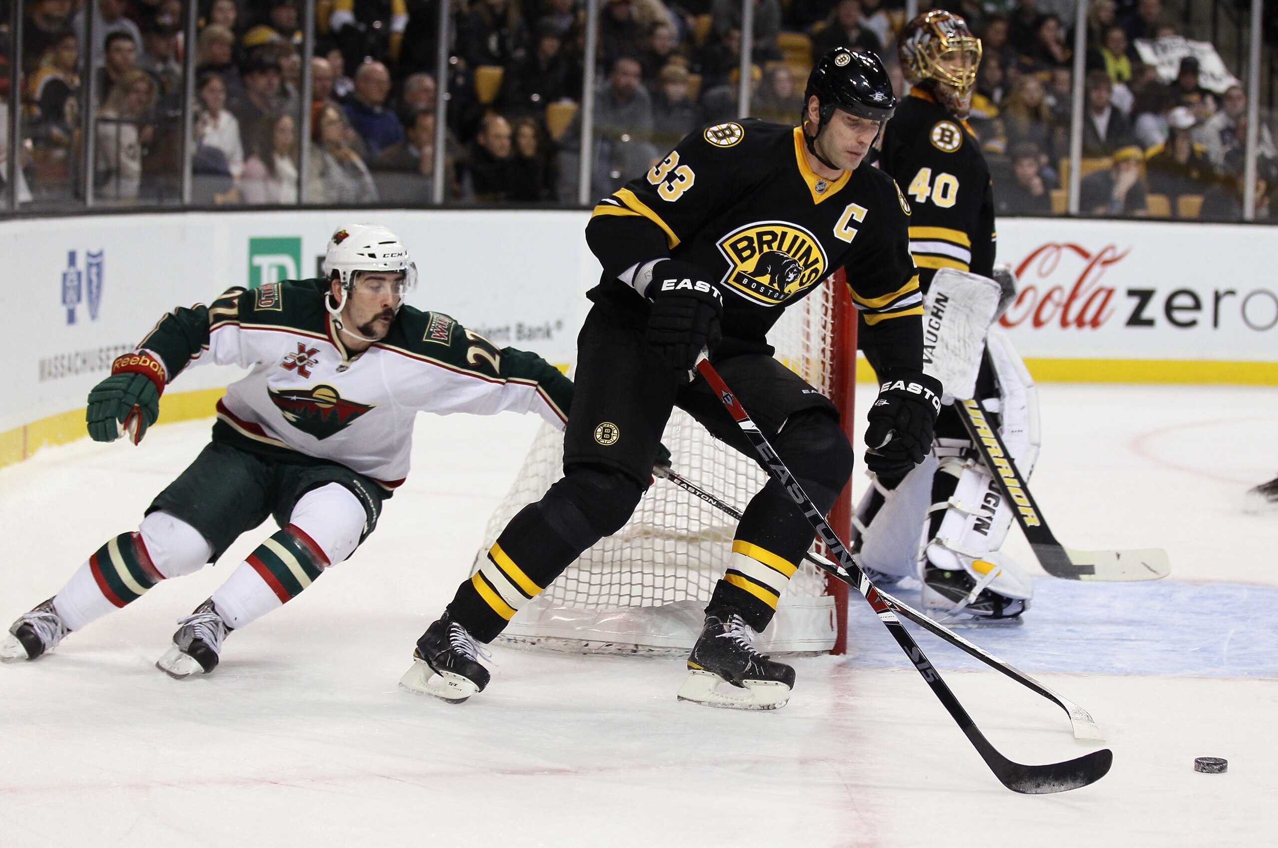 BOSTON, MA - JANUARY 06: Zdeno Chara #33 of the Boston Bruins takes the puck as Cal Clutterbuck #22 of the Minnesota Wild defends on January 6, 2010 at the TD Garden in Boston, Massachusetts. (Photo by Elsa/Getty Images) BOSTON, MA - JANUARY 06: Zdeno Chara #33 of the Boston Bruins takes the puck as Cal Clutterbuck #22 of the Minnesota Wild defends on January 6, 2010 at the TD Garden in Boston, Massachusetts. (Photo by Elsa/Getty Images)