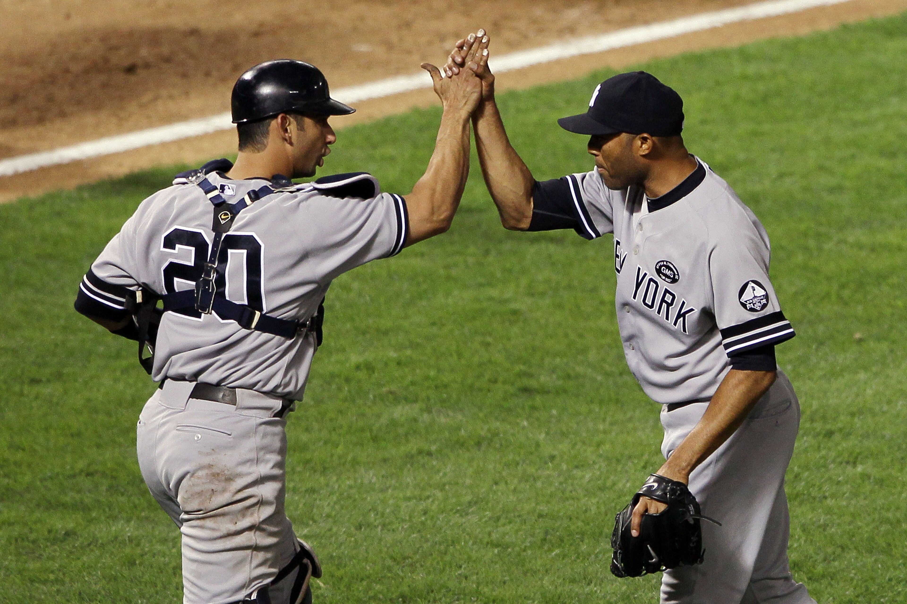 ARLINGTON, TX - OCTOBER 15:  Mariano Rivera #42 and Jorge Posada #20 of the New York Yankees celebrate after defeating the Texas Rangers by a score of 6-5 to win Game One of the ALCS during the 2010 MLB Playoffs at Rangers Ballpark in Arlington on October