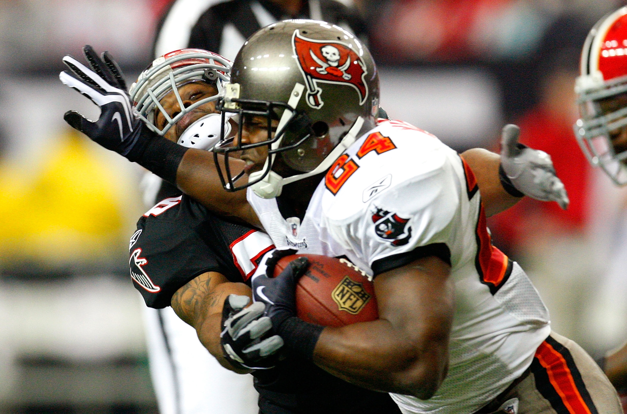 ATLANTA - NOVEMBER 29:  Cadillac Williams #24 of the Tampa Bay Buccaneers stiff arms Erik Coleman #26 of the Atlanta Falcons at Georgia Dome on November 29, 2009 in Atlanta, Georgia.  (Photo by Kevin C. Cox/Getty Images)