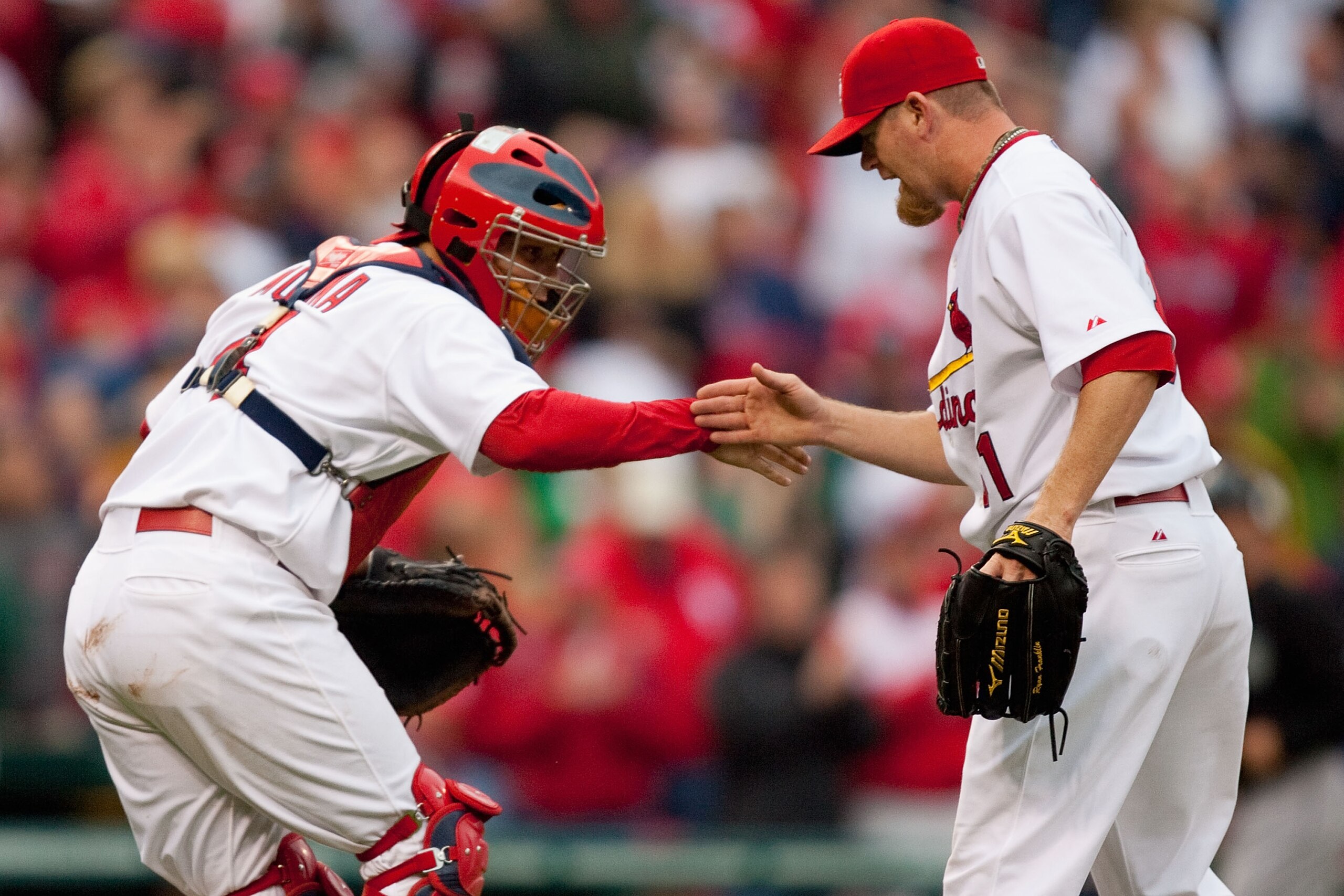 ST. LOUIS - MAY 20: Yadier Molina #4 and Ryan Franklin #31 both of the St. Louis Cardinals congratulate each other after beating the Florida Marlins at Busch Stadium on May 20, 2010 in St. Louis, Missouri.  The Cardinals beat the Marlins 4-2.  (Photo by D
