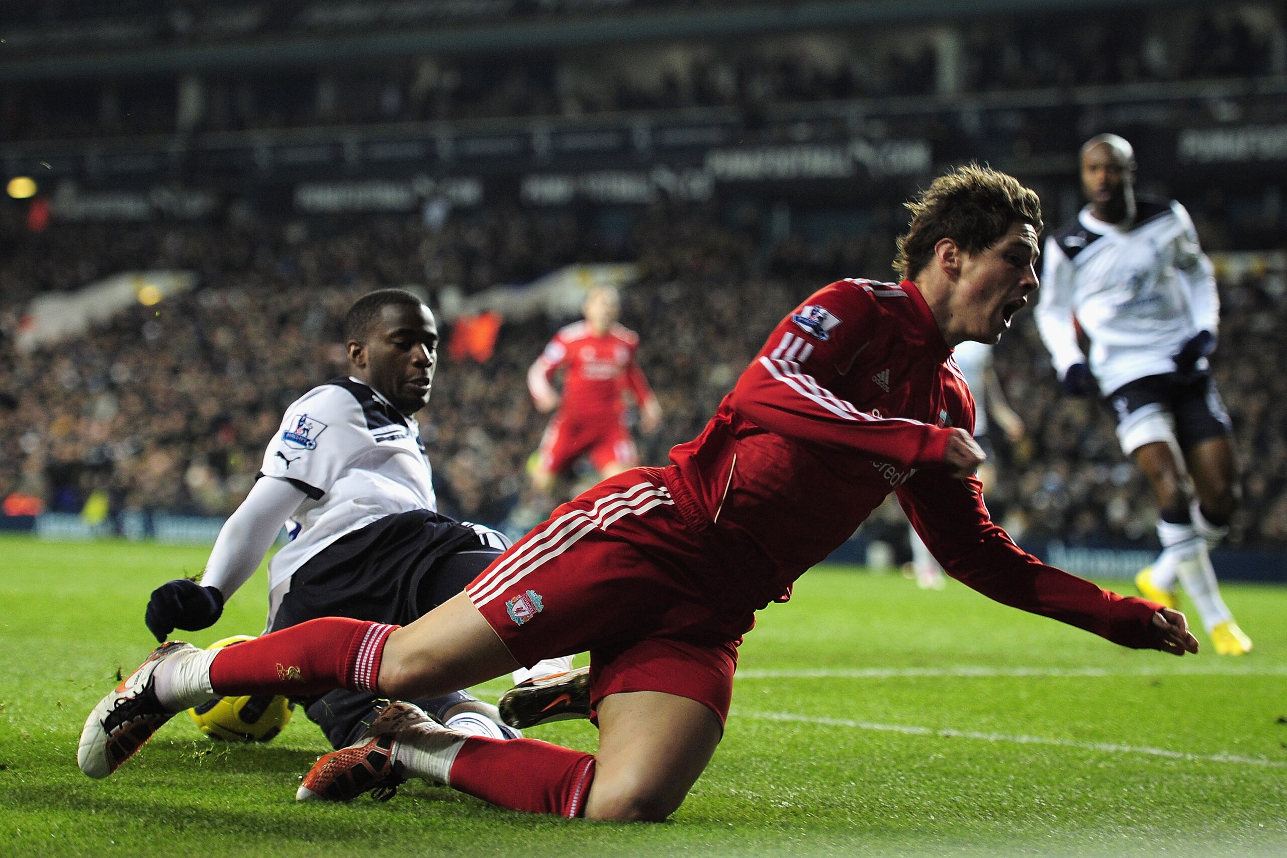 LONDON, ENGLAND - NOVEMBER 28:  Fernando Torres of Liverpool is tackled by Sebastien Bassong of Tottenham Hotspur during the Barclays Premier League match between Tottenham Hotspur and Liverpool at White Hart Lane on November 28, 2010 in London, England. 