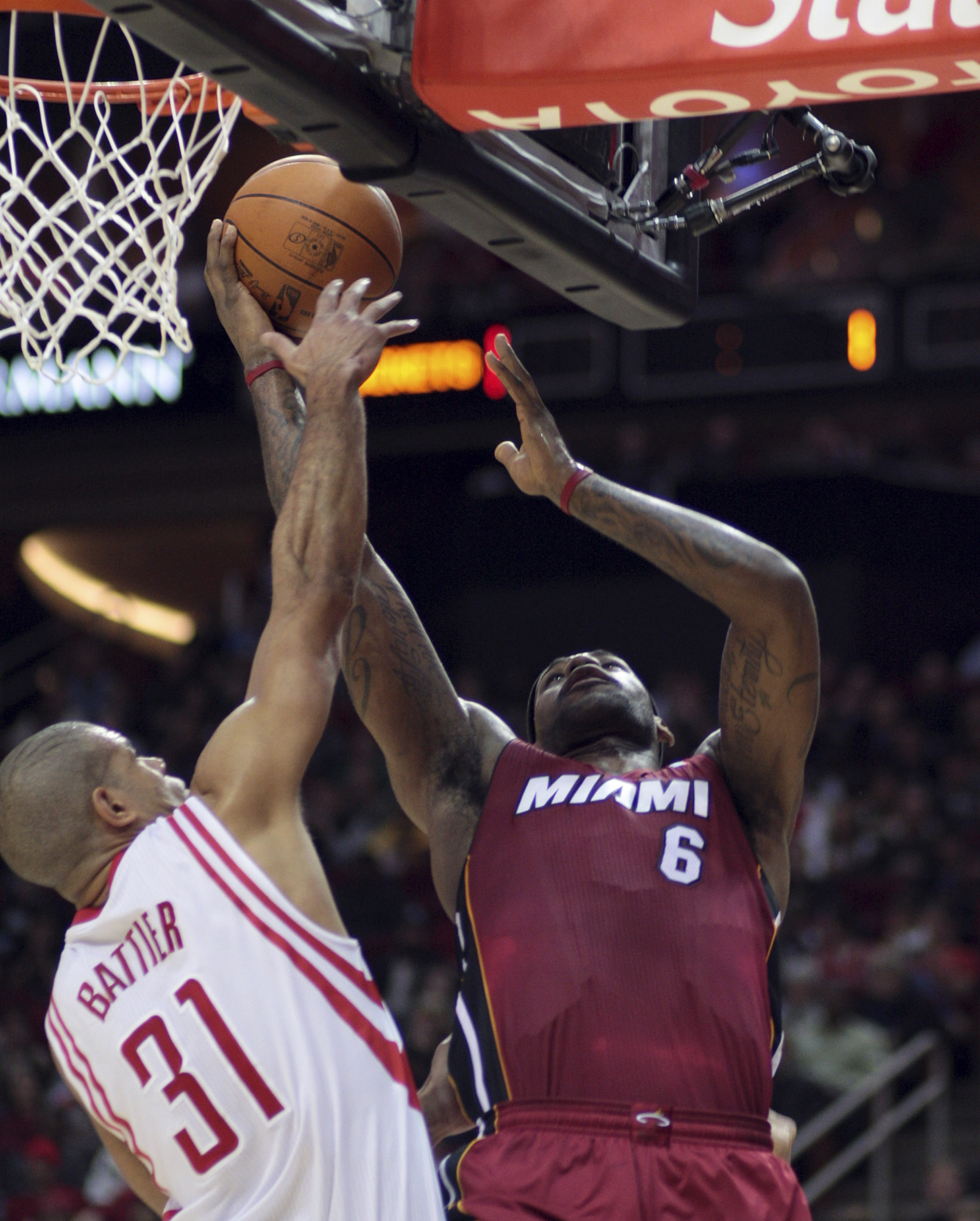 HOUSTON - DECEMBER 29:  LeBron James #6 of the Miami Heat drives to the basket over Houston Rockets' Shane Battier #31 in the first half at Toyota Center on December 29, 2010 in Houston, Texas.  NOTE TO USER: User expressly acknowledges and agrees that, b