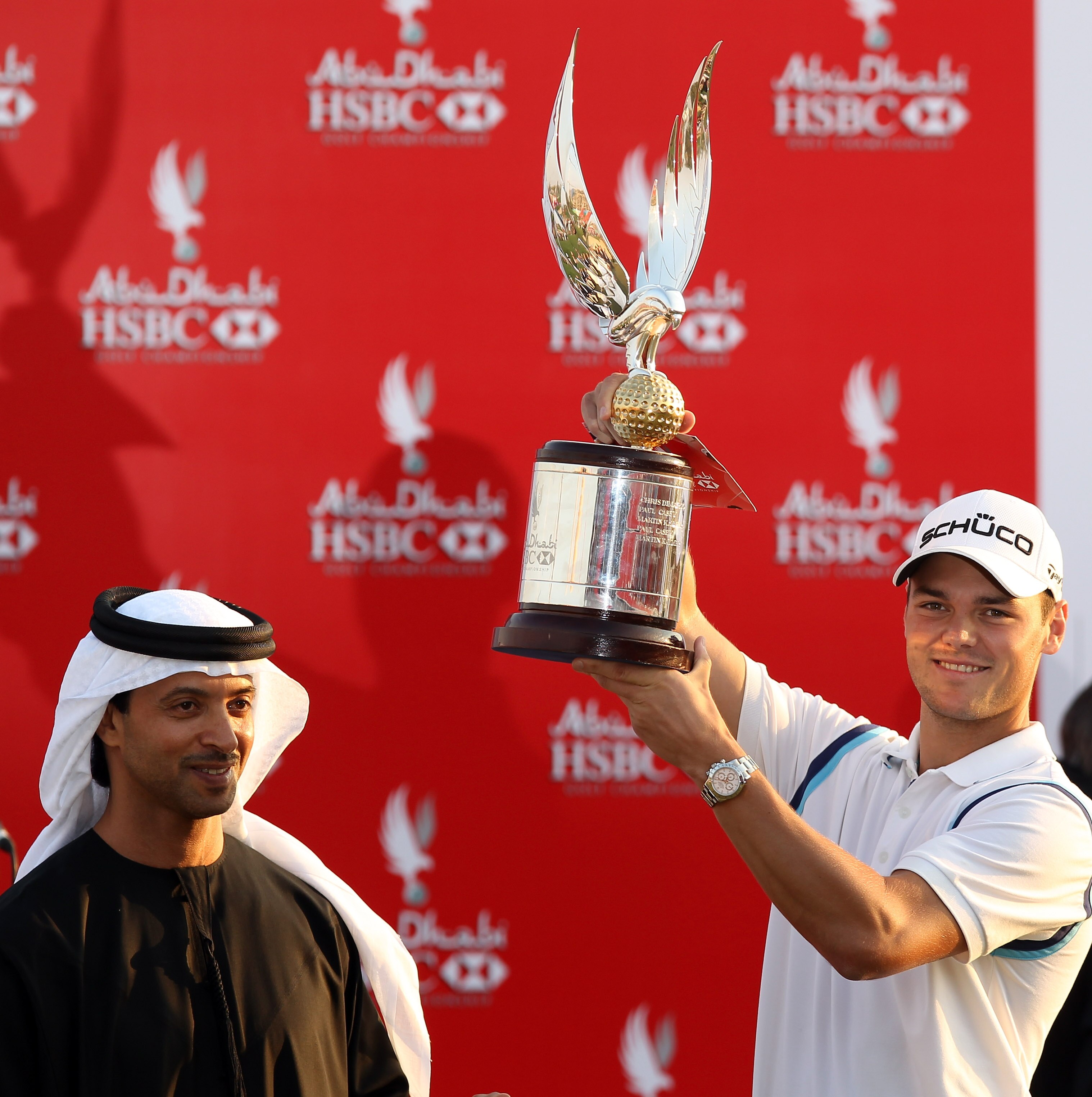 ABU DHABI, UNITED ARAB EMIRATES - JANUARY 23: Martin Kaymer of Germany is presented with the trophy by His Highness Sheikh Hazza Bin Zayed Al Nahyan The National Security Advisor, Vice Chairman of the Executive Council, and Chairman of the Abu Dhabi Spor