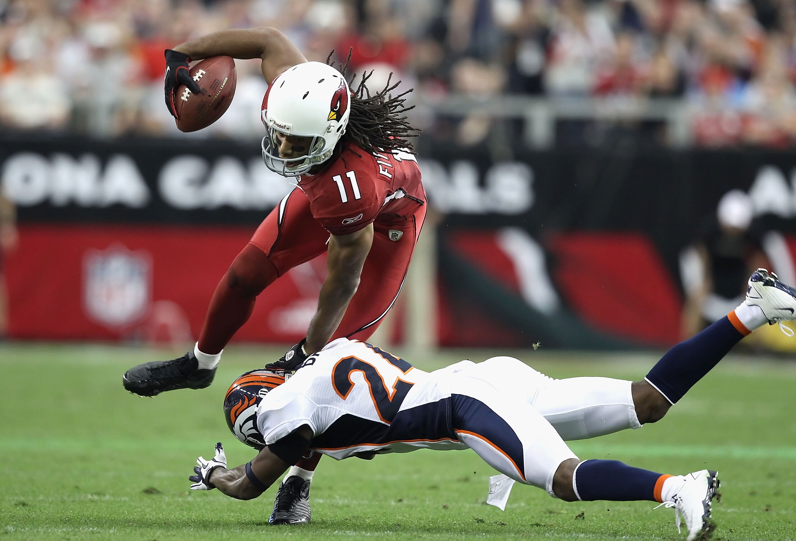 GLENDALE, AZ - DECEMBER 12:  Wide receiver Larry Fitzgerald #11 of the Arizona Cardinals makes a reception against the Denver Broncos during the NFL game at the University of Phoenix Stadium on December 12, 2010 in Glendale, Arizona.  (Photo by Christian