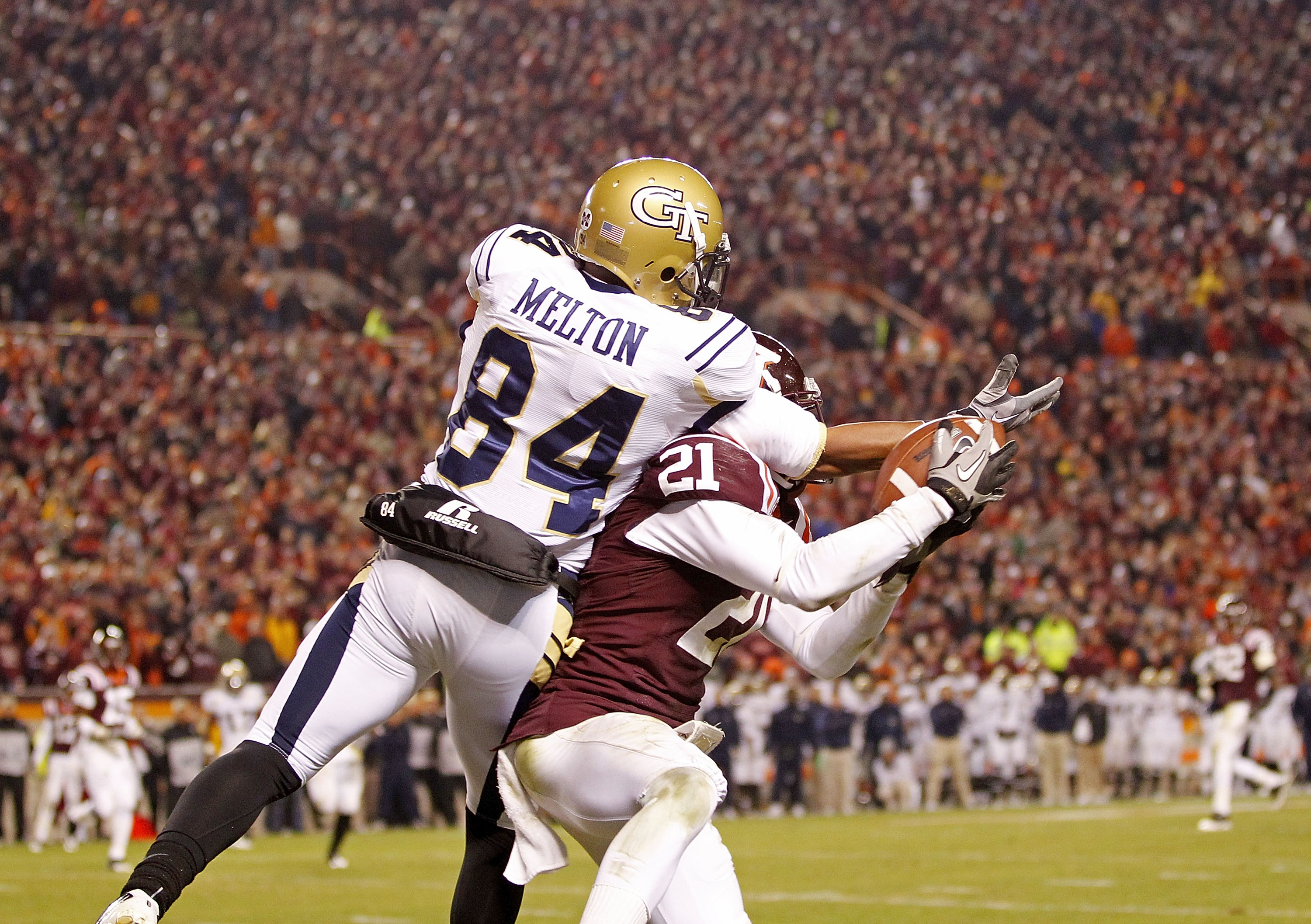 BLACKSBURG, VA - NOVEMBER 04:  Cornerback Rashad Carmichael #21 of the Virginia Tech Hokies intercepts a pass intended for wide receiver Tyler Melton #84 of the Georgia Tech Yellow Jackets in the end zone in the final seconds at Lane Stadium on November 4