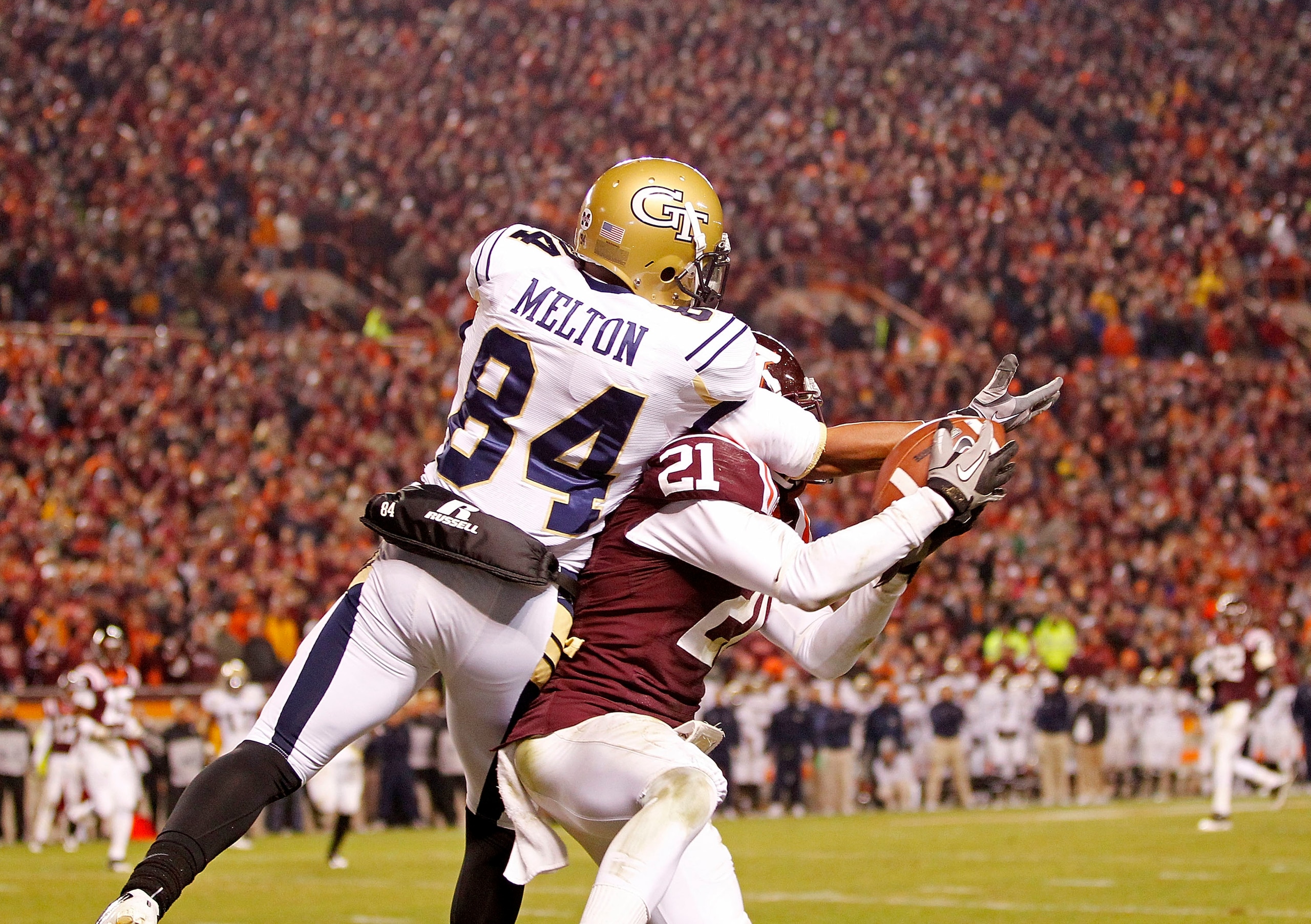BLACKSBURG, VA - NOVEMBER 04:  Cornerback Rashad Carmichael #21 of the Virginia Tech Hokies intercepts a pass intended for wide receiver Tyler Melton #84 of the Georgia Tech Yellow Jackets in the end zone in the final seconds at Lane Stadium on November 4